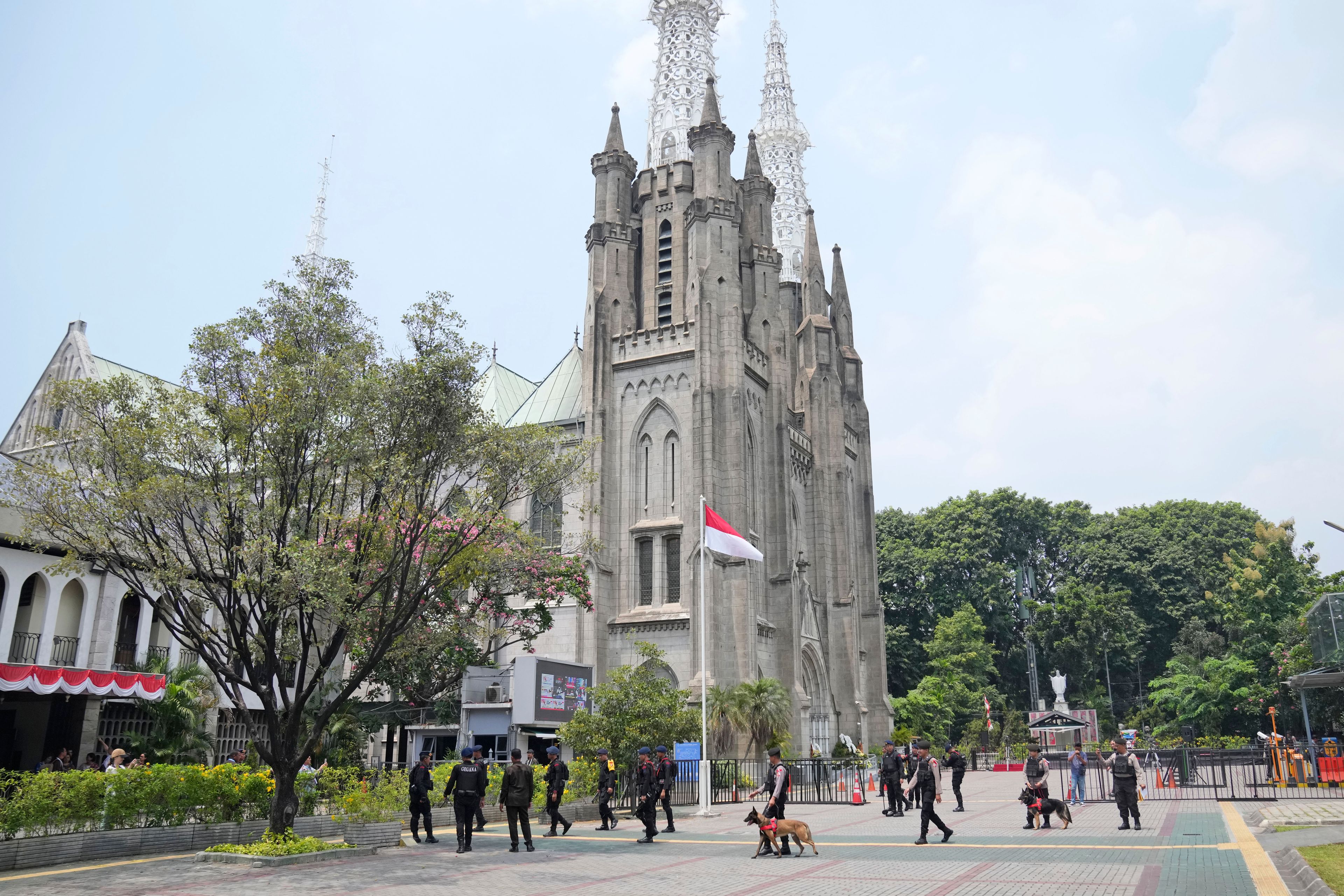 Members of a police bomb squad canine unit sweep the Jakarta Cathedral compound ahead of the visit of Pope Francis in Jakarta, Indonesia, Wednesday, Sept. 4, 2024.