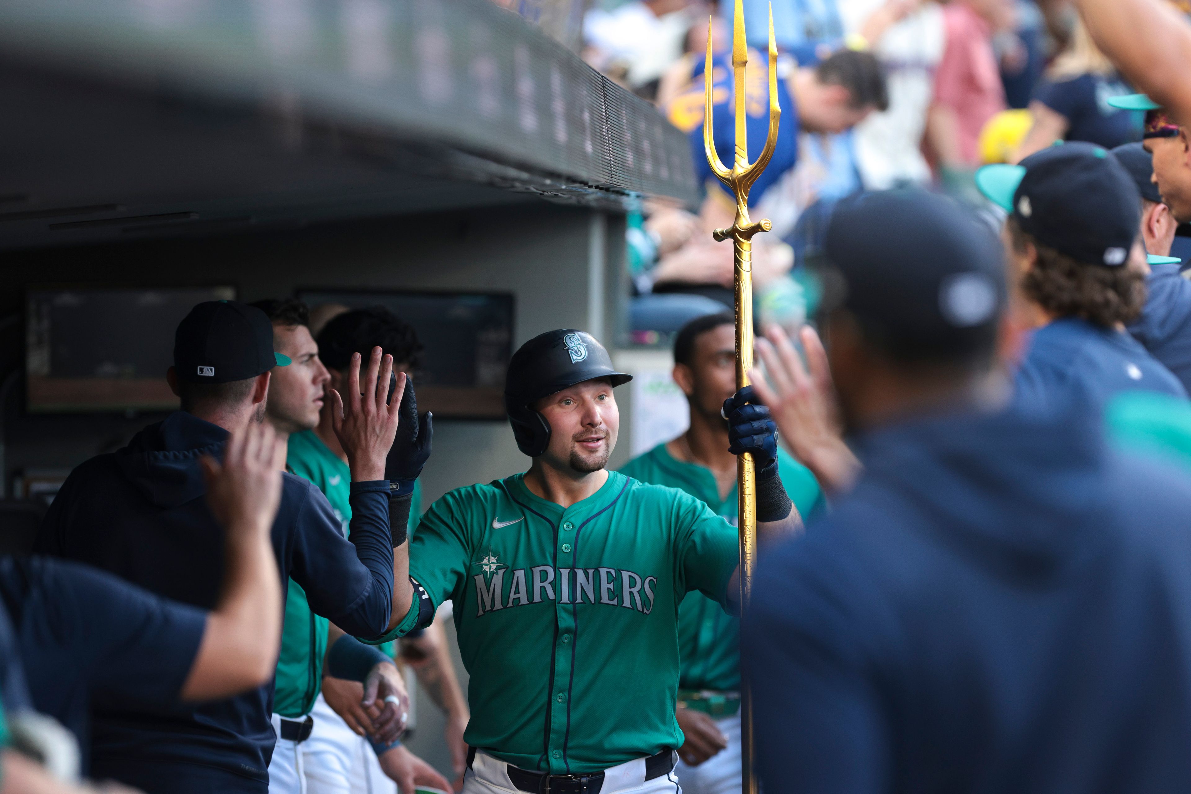 The Mariners' Cal Raleigh, center, celebrates in the dugout after hitting a solo home run during the second inning of a game against the Athletics on Saturday, May 11, 2024, in Seattle.