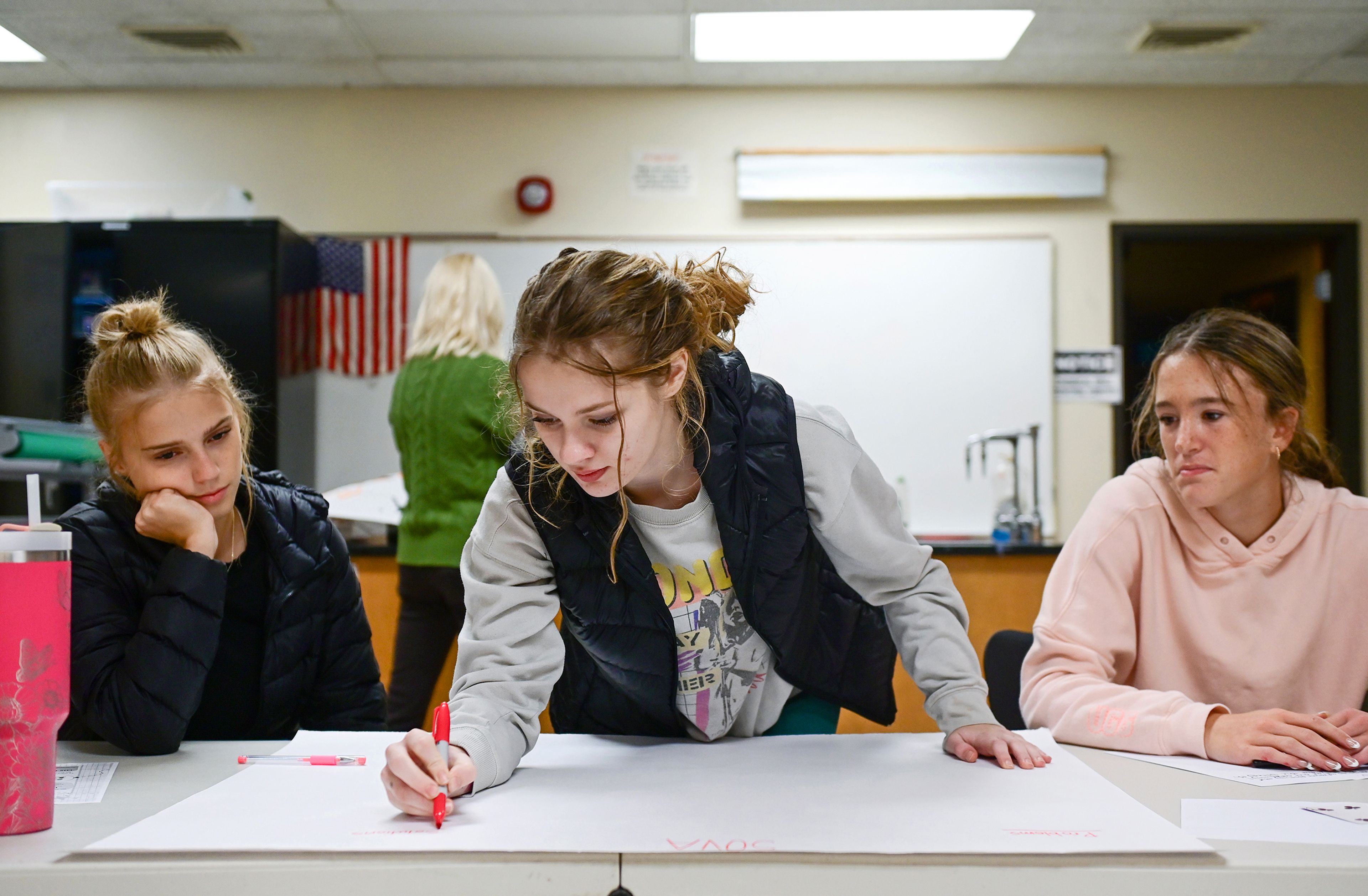 Katie Wren, left, a junior at Lewiston High School, Heidi Spitzer, center, a senior at Tammany High School, and Lexie York, a freshman at Clarkston High School, discuss community issues and possible solutions during a small groups portion of a Students of the Valley Advocacy meeting Monday at Asotin High School.,