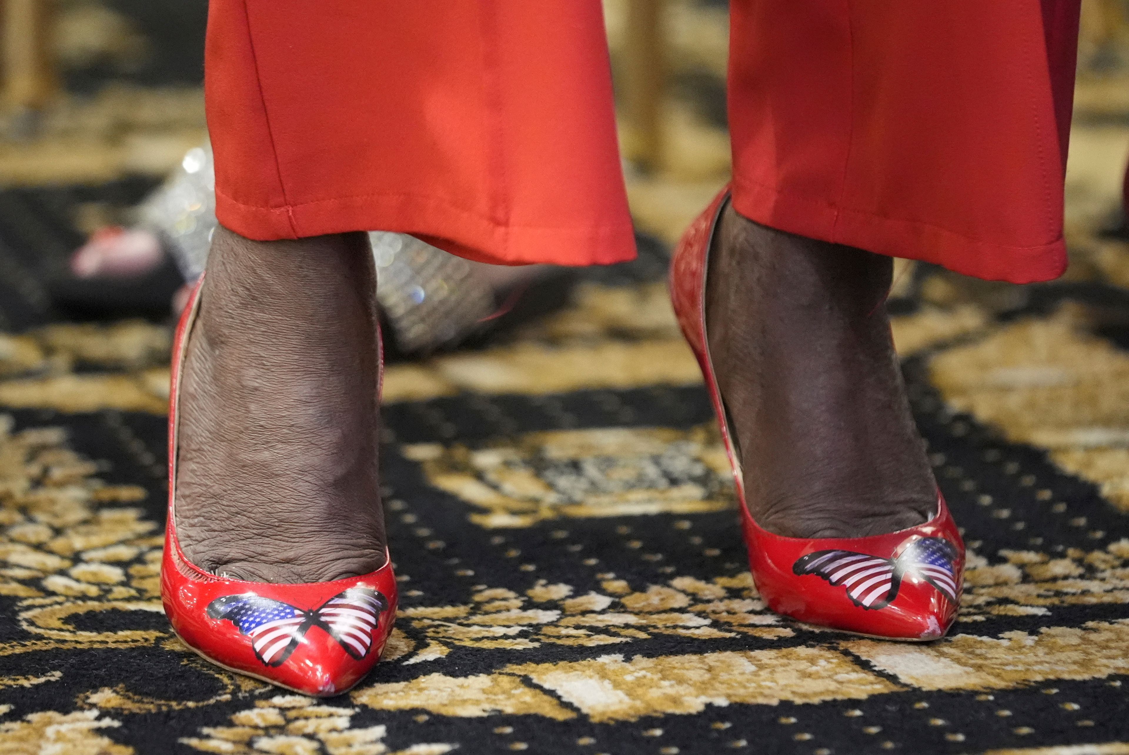 An attendee wears patriotic shoes to the roundtable of Latino leaders with Republican presidential nominee, former President Donald Trump, Tuesday, Oct. 22, 2024, in Doral, Fla. (AP Photo/Alex Brandon)