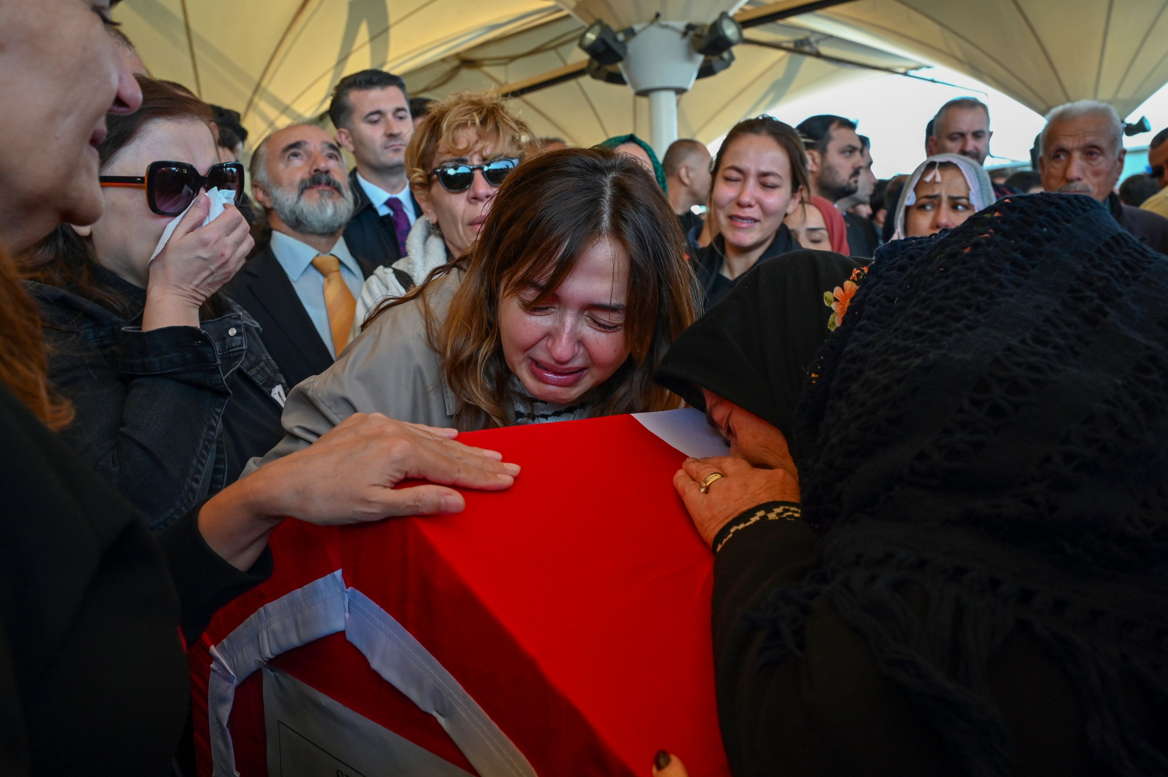 Relatives of Cengiz Coskun, who was killed during an attack by PKK members at the Turkish aerospace and defense company TUSAS on Wednesday, mourn during a funeral at Karsiyaka mosque, in Ankara, Thursday, Oct. 24, 2024. (AP Photo/Ali Unal)