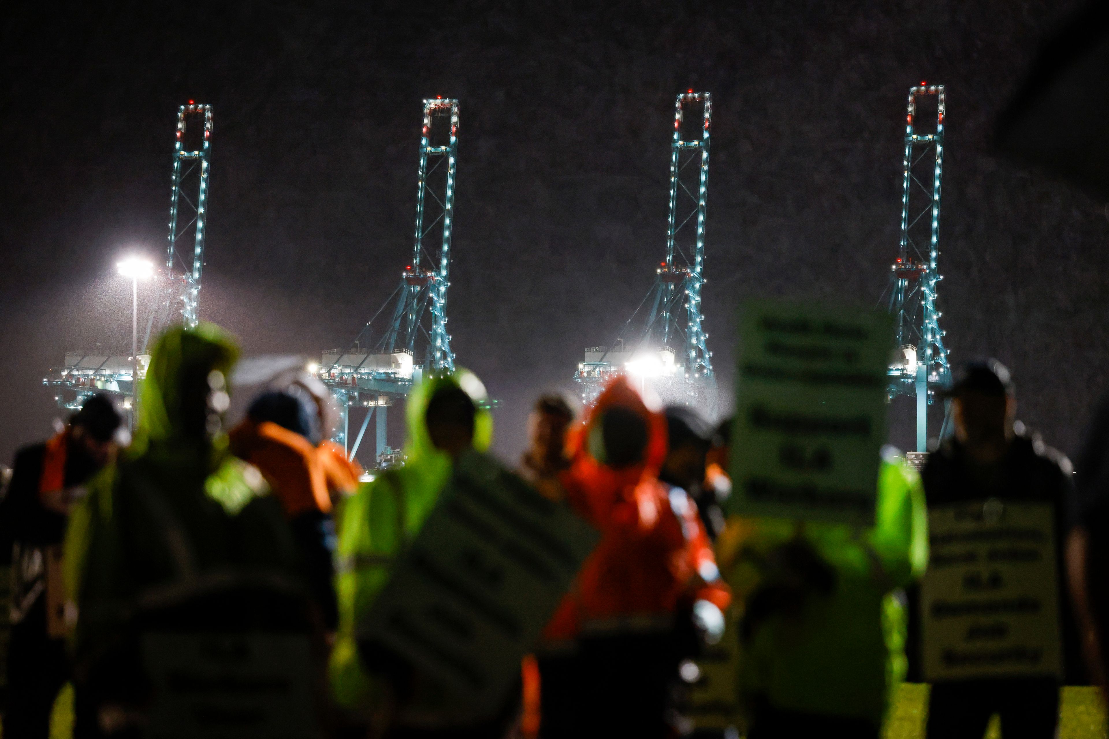 Hundreds of longshoremen strike together outside of the Virginia International Gateway in Portsmouth, Va., Tuesday, Oct. 1, 2024. (Billy Schuerman/The Virginian-Pilot via AP)