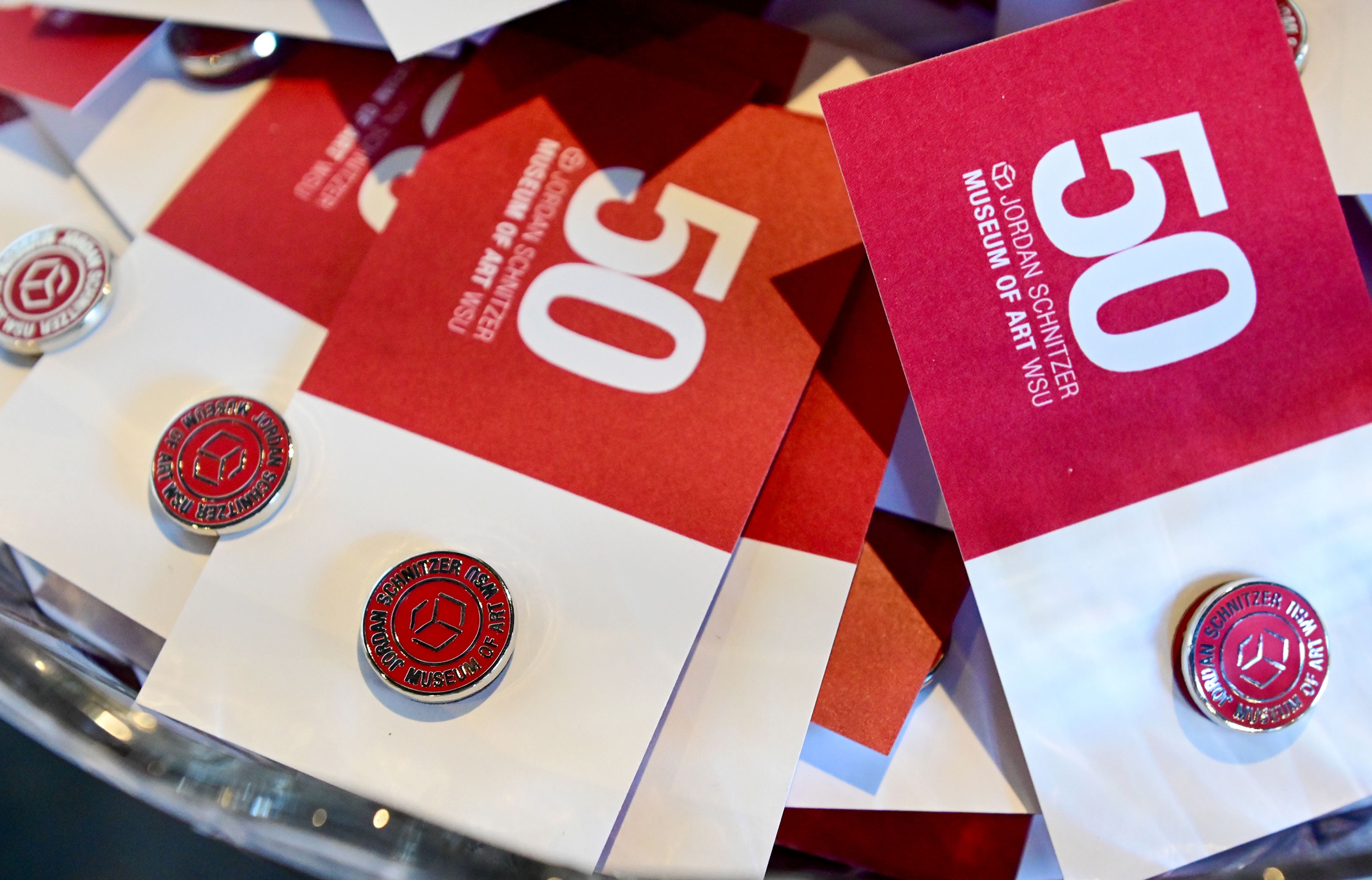 Commemorative pins to celebrate the Washington State University art museums 50th anniversary are given out Thursday at the Jordan Schnitzer Museum of Art at Washington State University in Pullman.