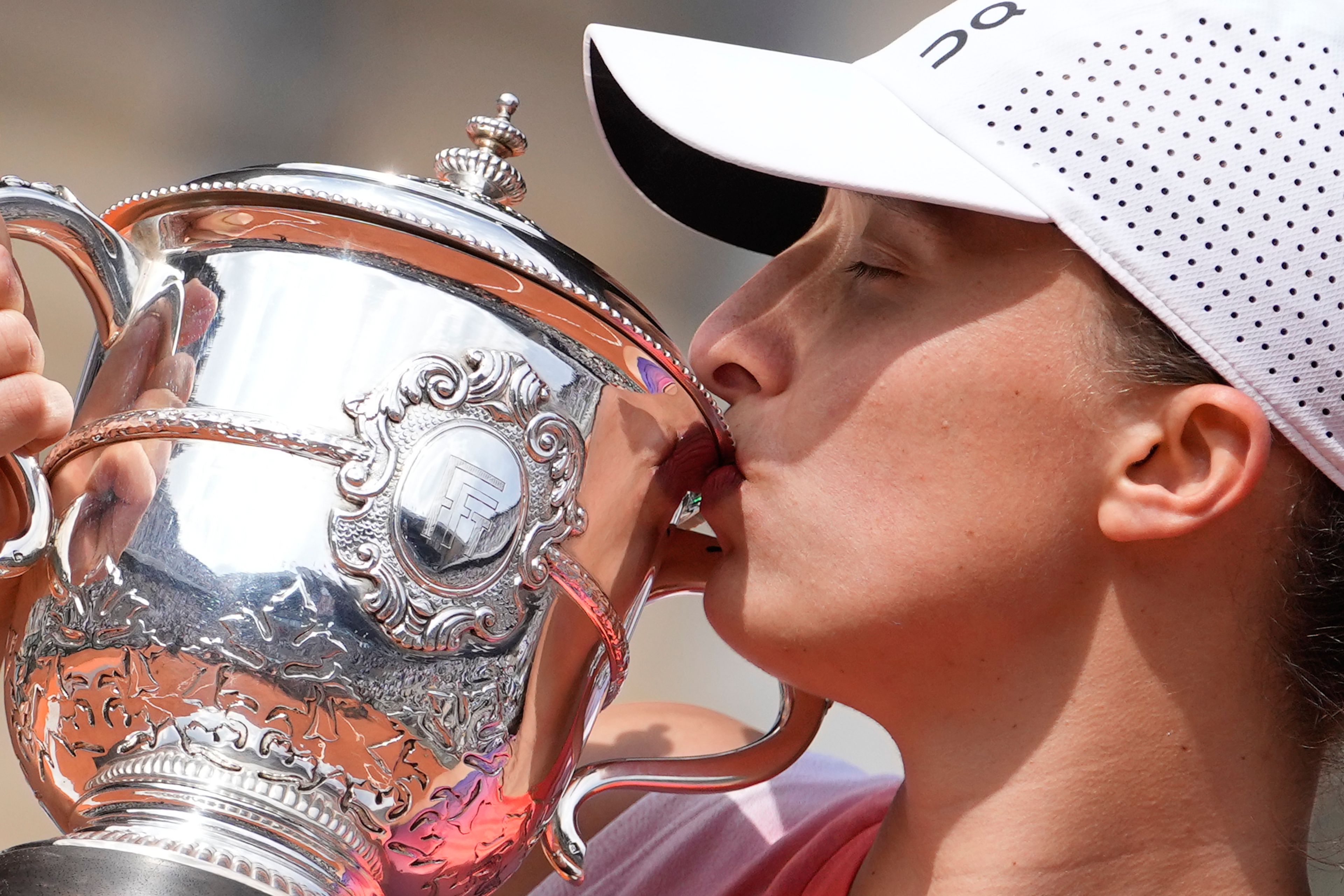 Poland's Iga Swiatek kisses the trophy after winning the women's final of the French Open tennis tournament against Italy's Jasmine Paolini at the Roland Garros stadium in Paris, France, Saturday, June 8, 2024.