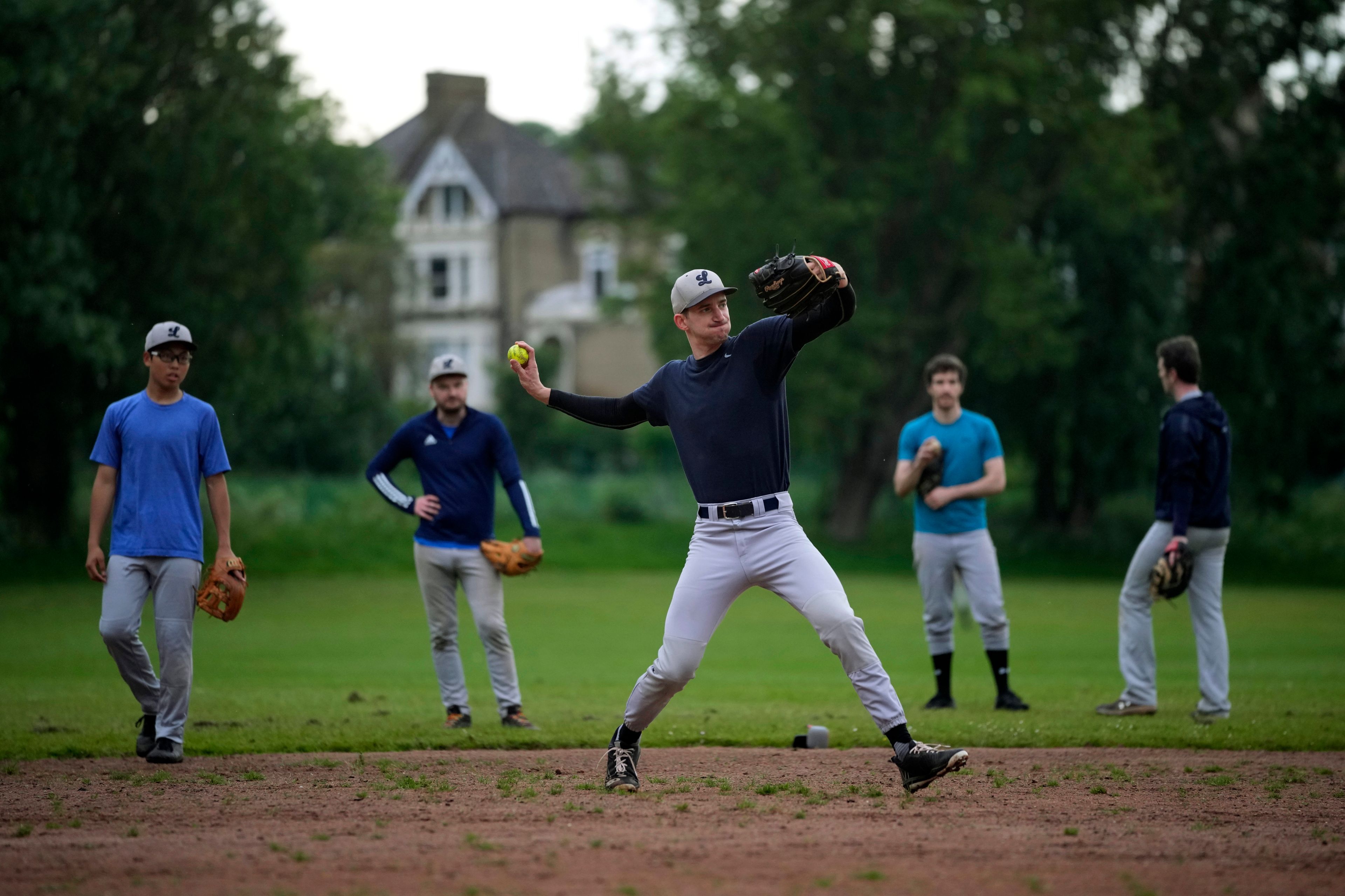 Members of the UK baseball team London Mets practice during a training session at the Finsbury Park in London, Thursday, May 16, 2024. Baseball at the highest club level in Britain is competitive. Teams are mélange of locals and expats some with college and minor league experience.