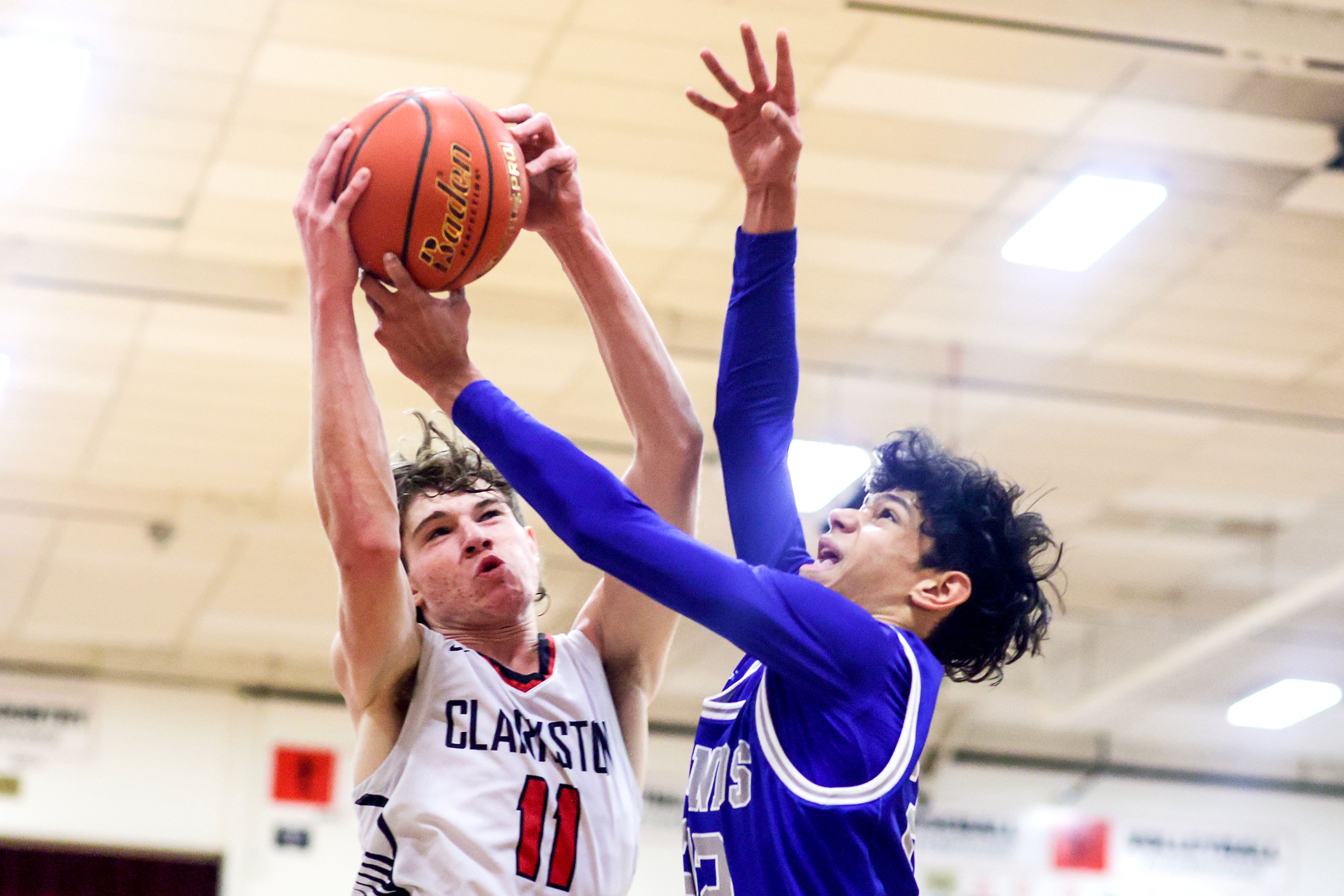 Clarkston forward Dustin Beck, left, fights for a rebound with Pullman guard Caleb Northcroft during Tuesday's Class 2A Greater Spokane League boys basketball game.