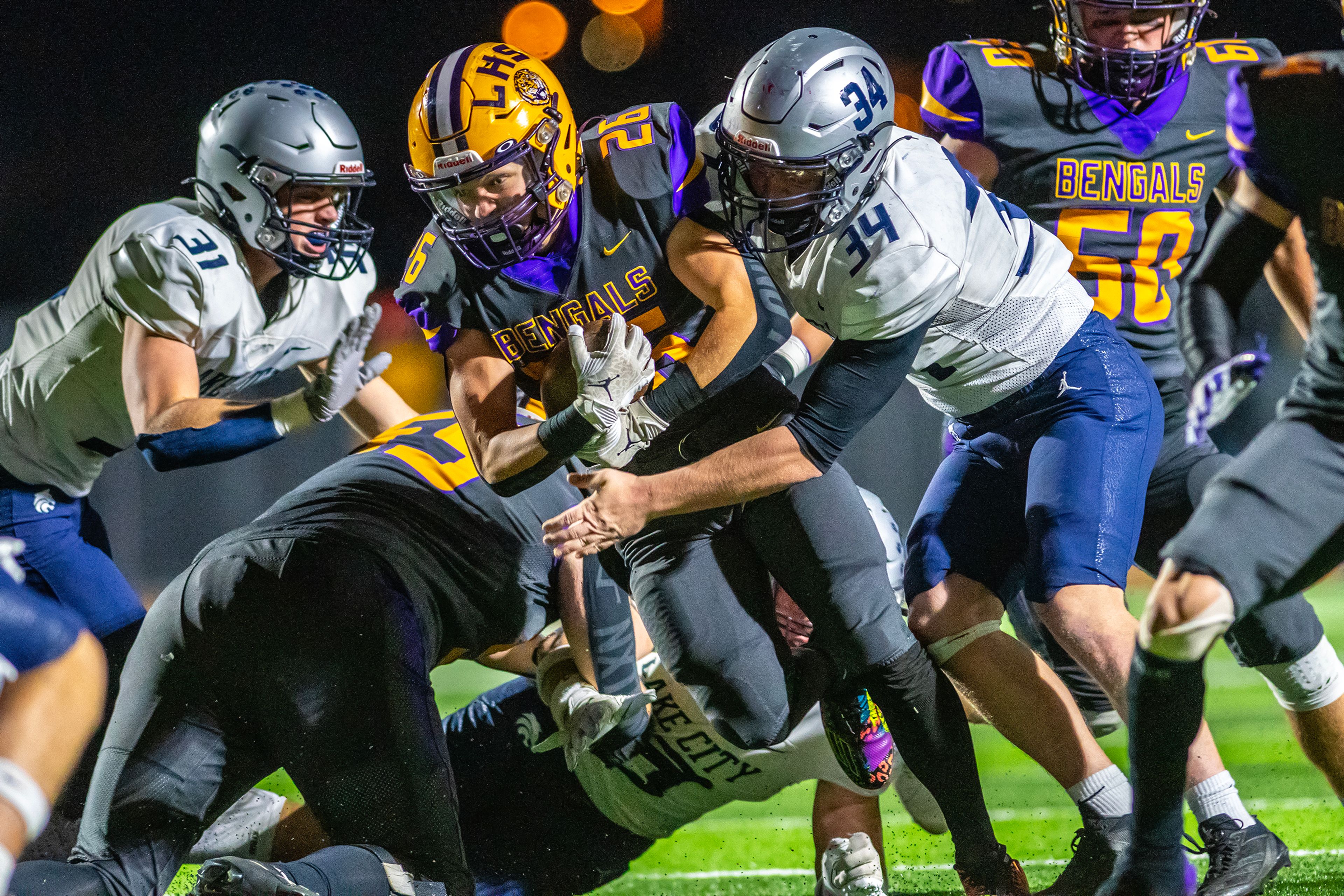 Lewiston running back Sawyer Casey is tackled by Lake City defensive lineman Landon Sheldon in a nonconference game Friday at Lewiston High School.,