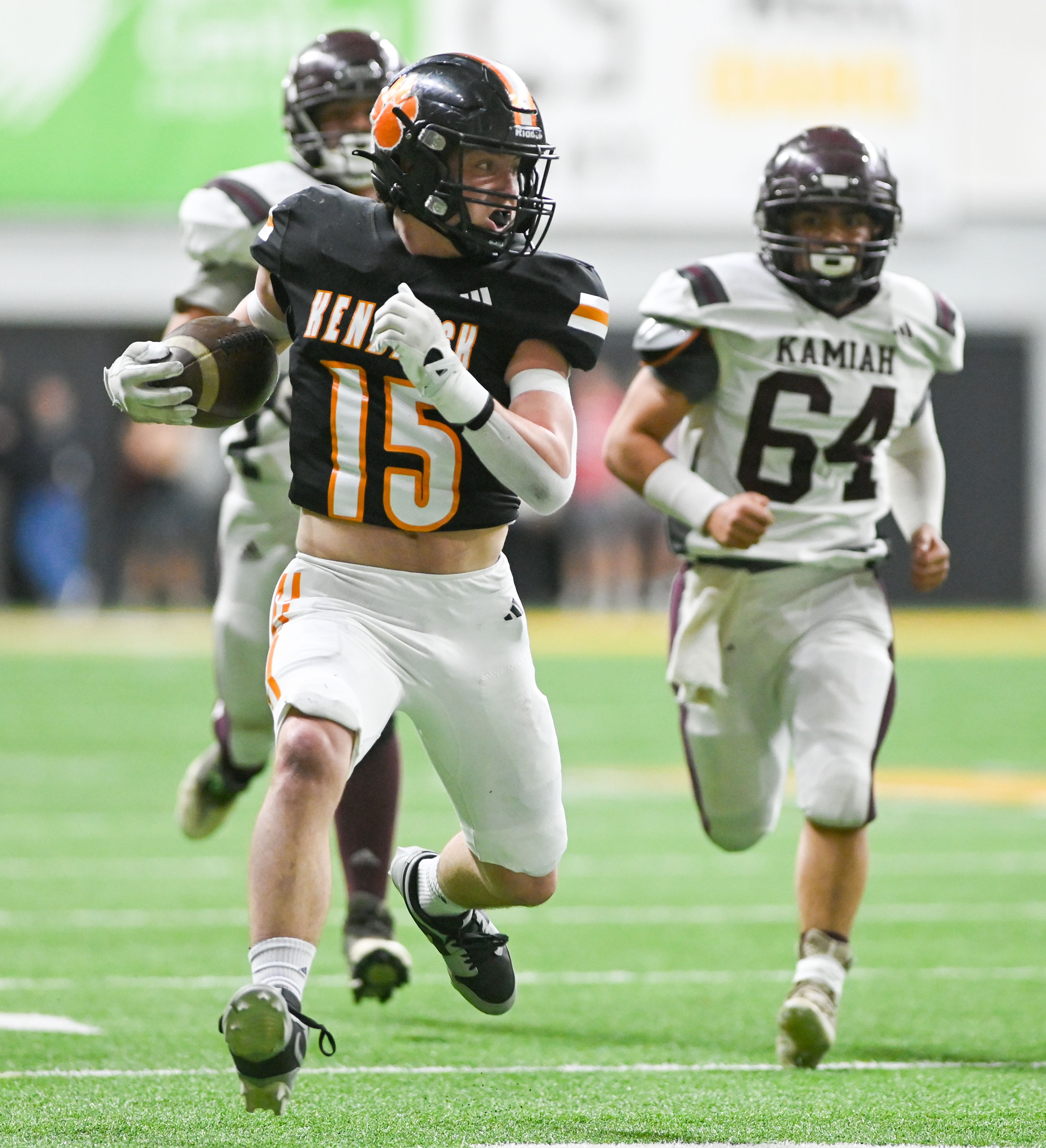 Kendrick’s Xavier Carpenter carries the ball in a breakaway play against Kamiah during an Idaho Class 2A state quarterfinal game at the P1FCU Kibbie Dome in Moscow.