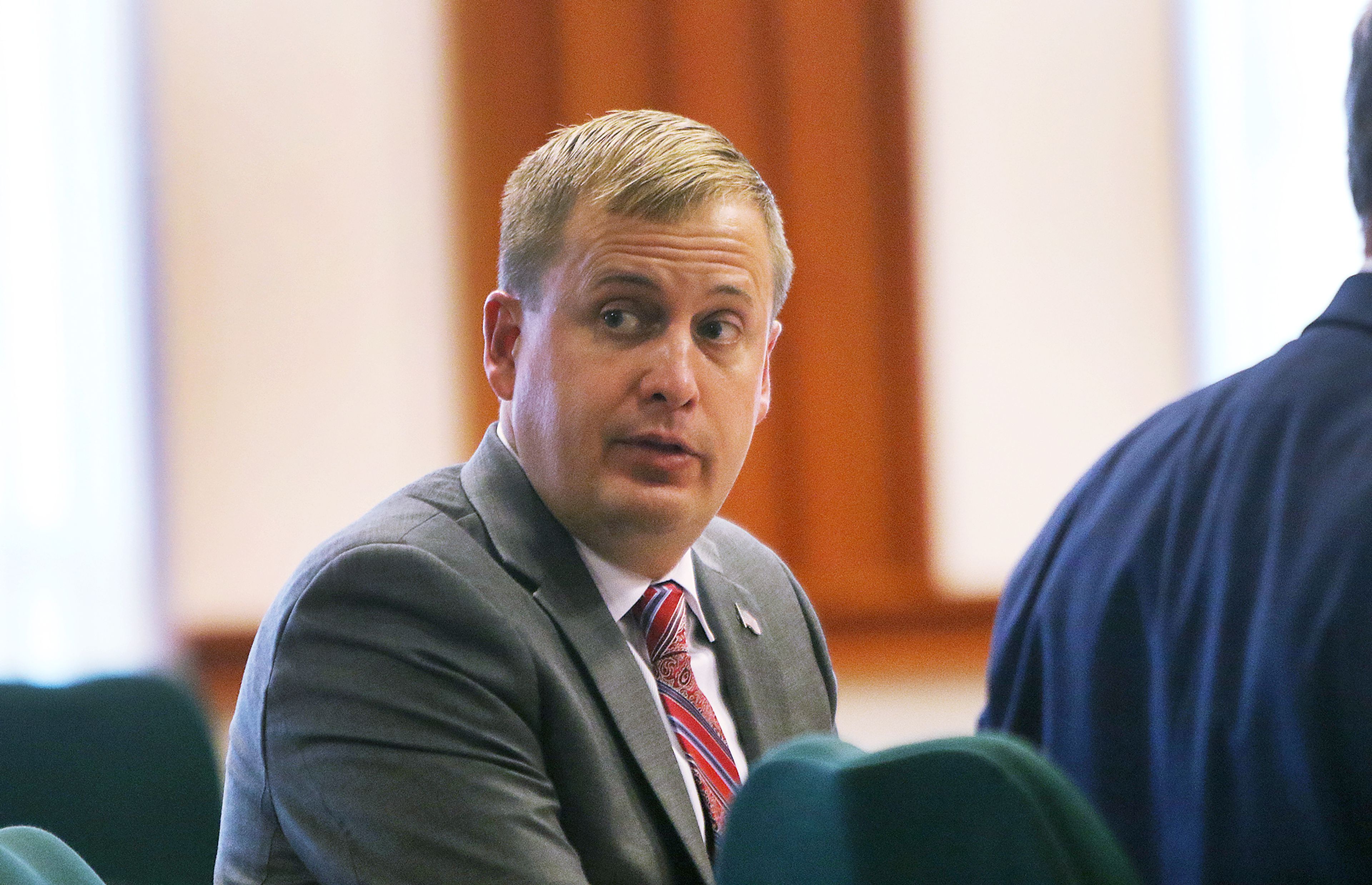 Former Idaho state Rep. Aaron von Ehlinger looks over his shoulder toward the gallery Tuesday during the opening day of testimony in his rape trial at the Ada County Courthouse in Boise.