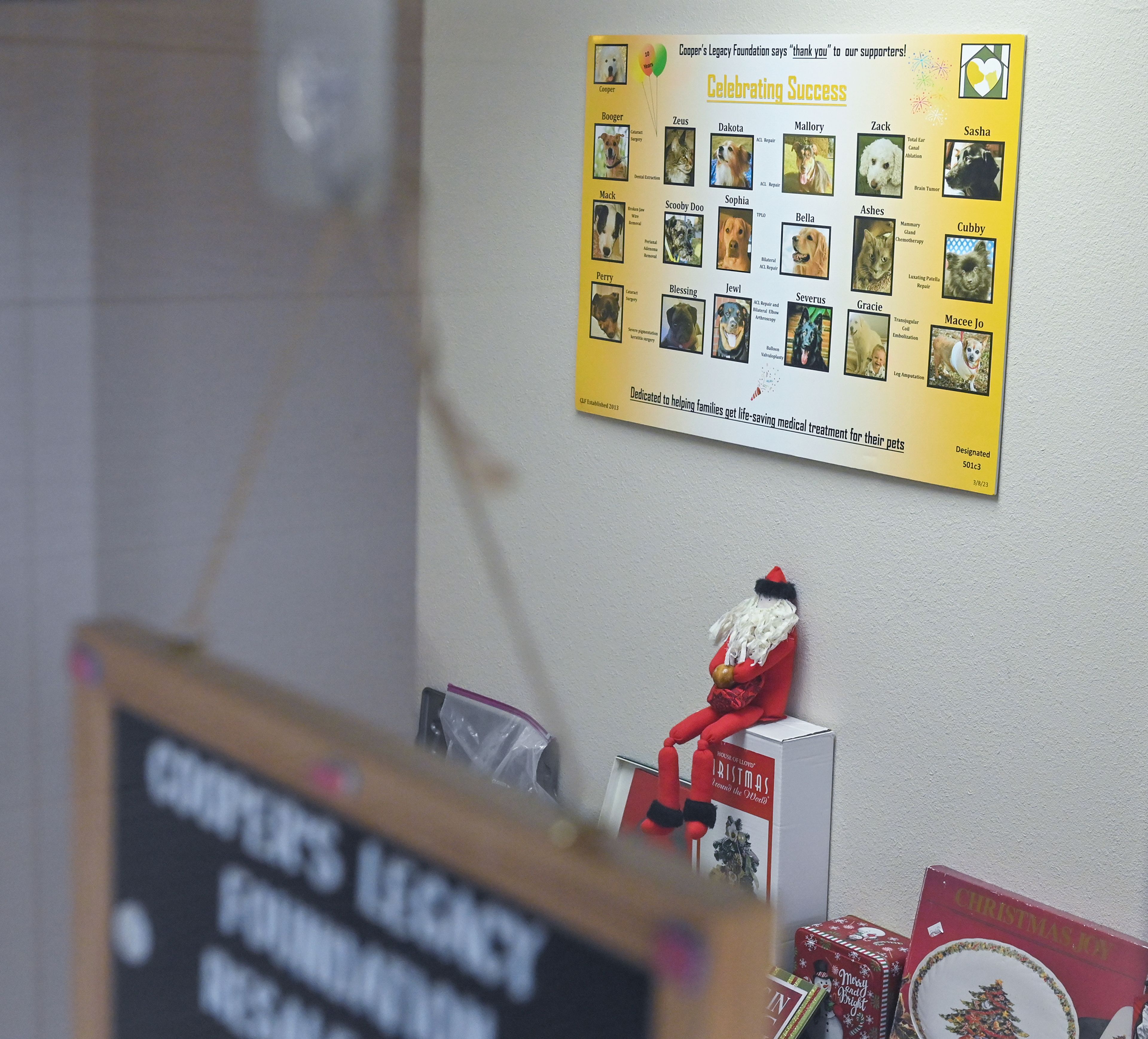 A poster displays success stories of pets helped by Cooper’s Legacy Foundation in the hallway leading to the foundation’s resale shop Wednesday in Pullman.