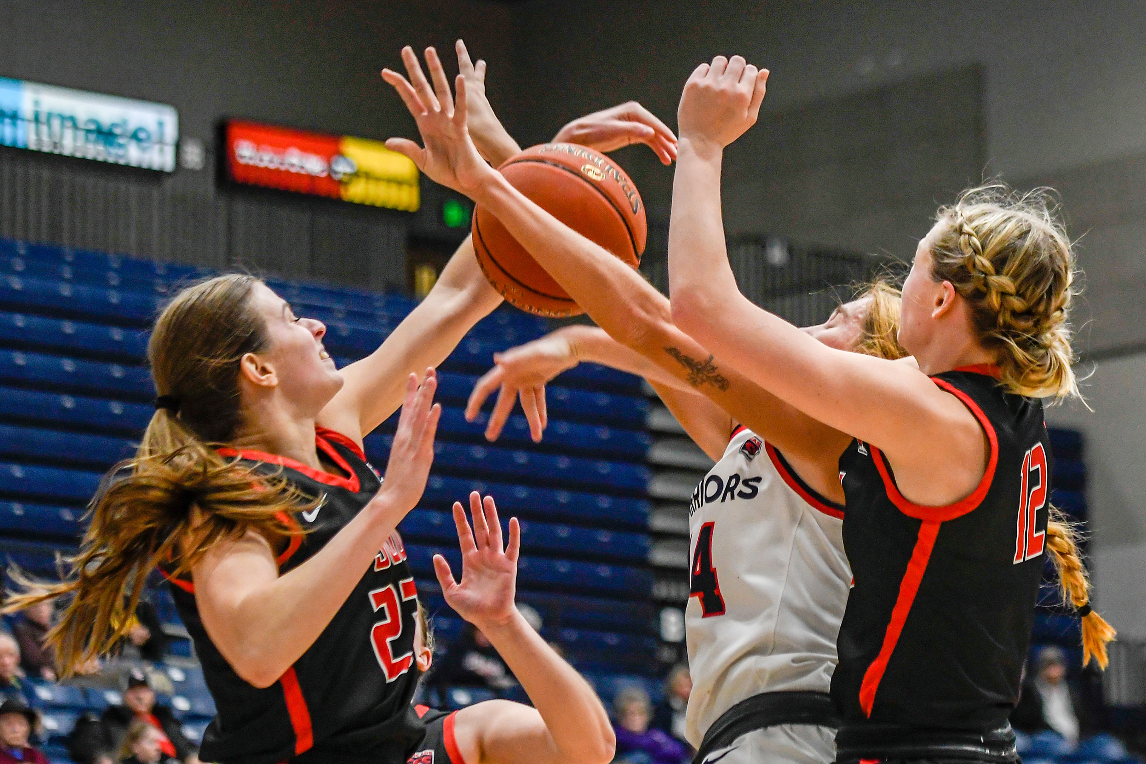 Lewis-Clark State forward Maddie Holm is swarmed by multiple Southern Oregon defenders during Saturday's Cascade Conference game at the P1FCU Activity Center.