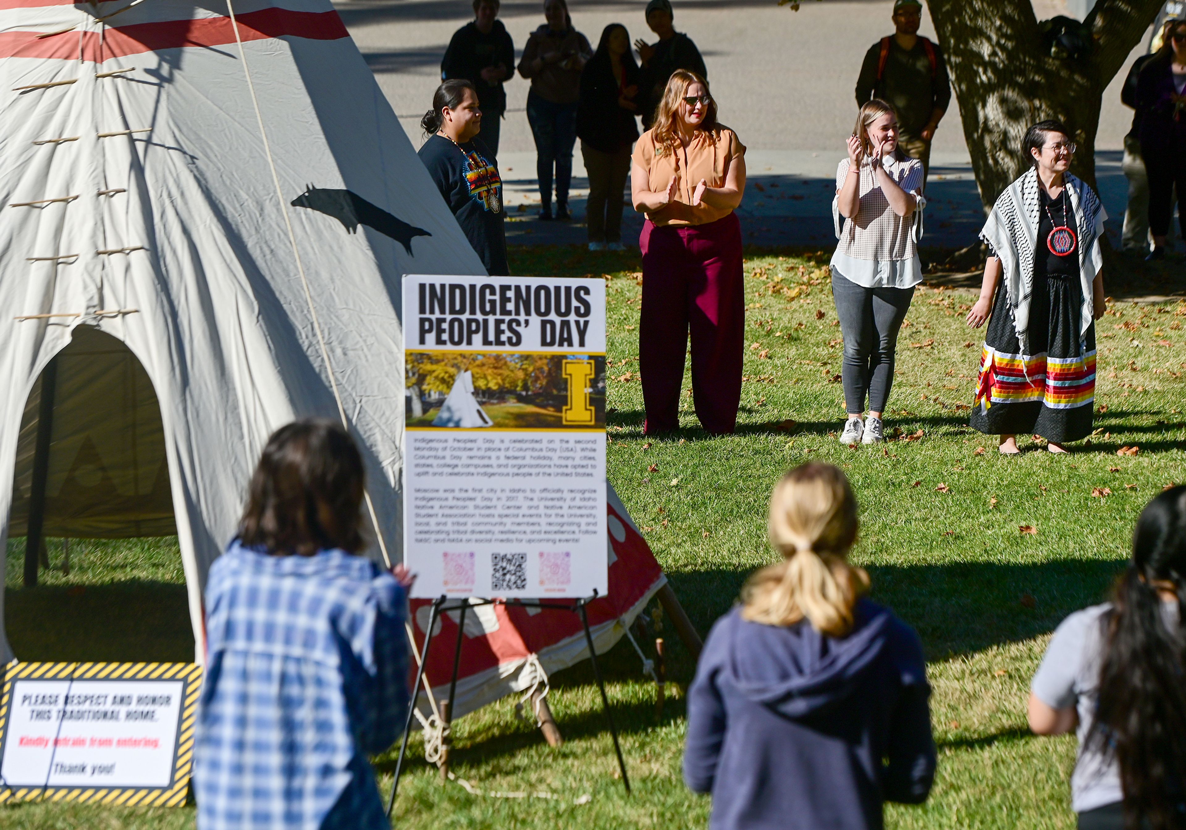 Participants clap from their place in a circle around a tepee after taking part in a round dance Monday during an Indigenous Peoples Day event hosted by the University of Idaho Native American Student Center on campus in Moscow.