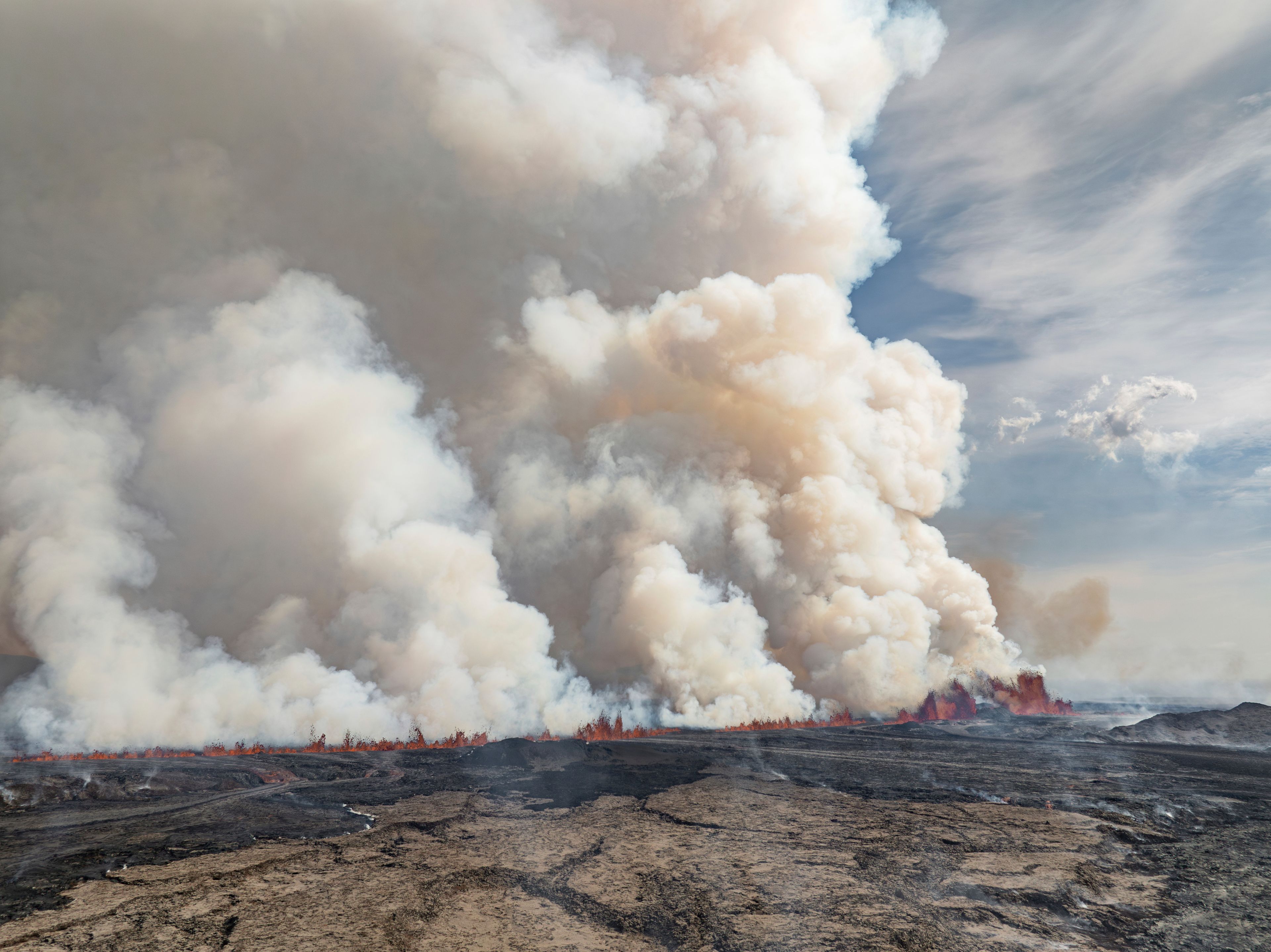 An eruptive fissure spews lava and smoke from a volcano in Grindavik, Iceland, Wednesday, May 29, 2024. A volcano in southwestern Iceland erupted Wednesday for the fifth time since December, spewing red lava that once again threatened the coastal town of Grindavik and led to the evacuation of the popular Blue Lagoon geothermal spa.