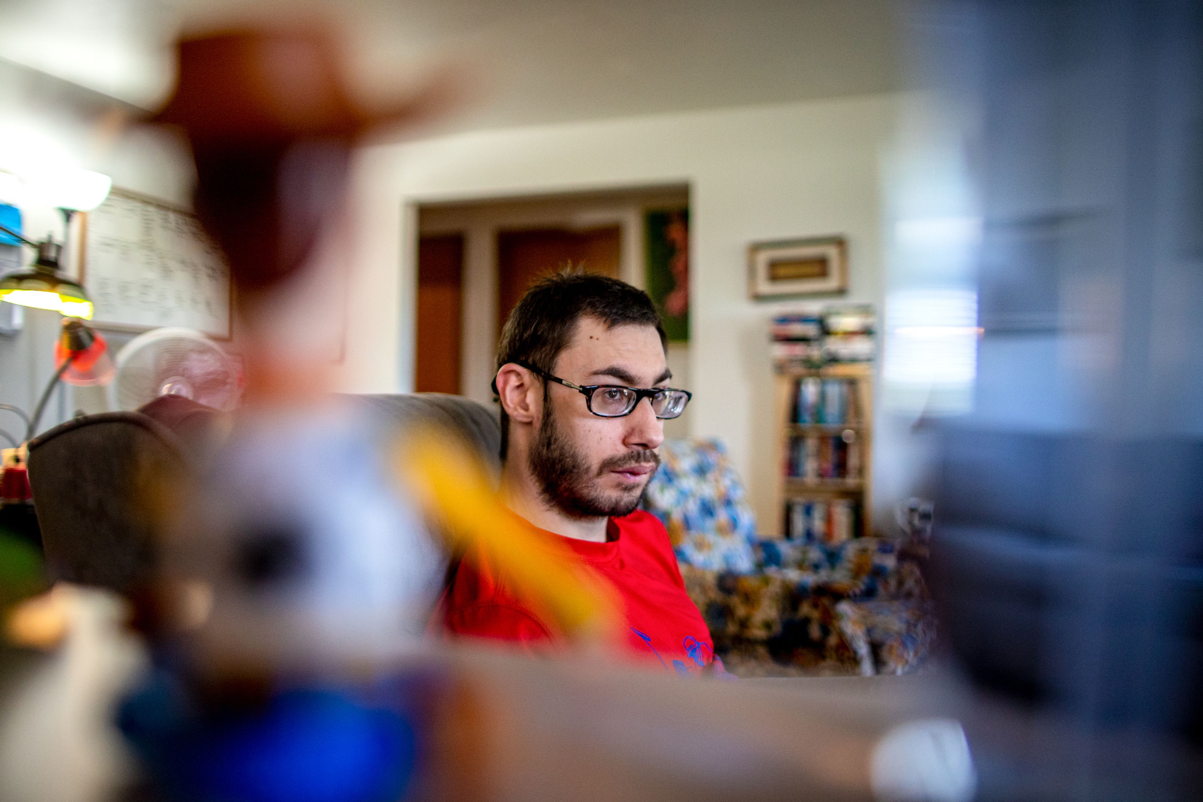 Kees Beehner, 28, watches TV in his favorite chair at his Opportunities Unlimited Inc. supported living resident in Lewiston on the morning of Sept. 21.