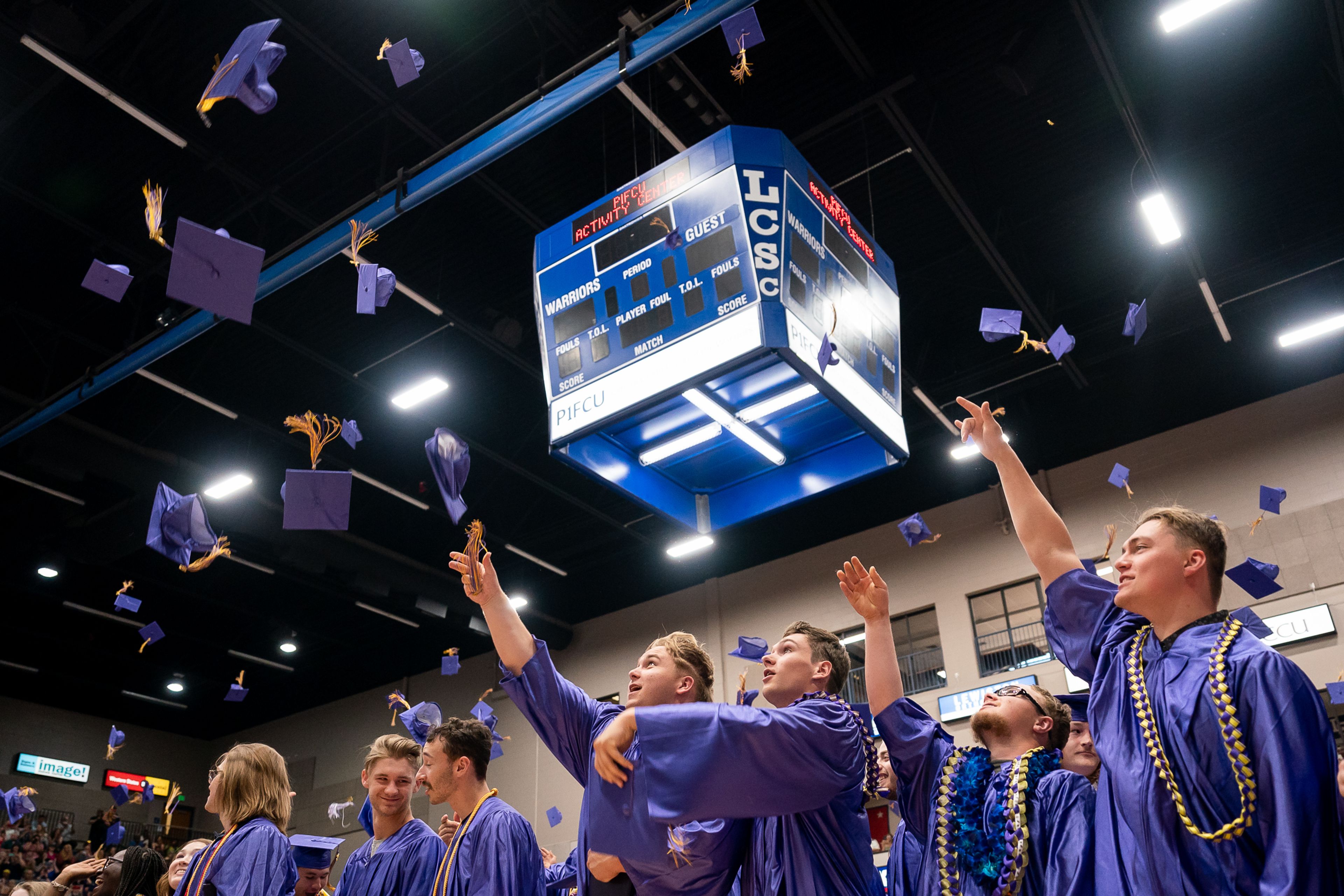 Students throw their caps into the air to celebrate graduating high school during Lewiston High School�s commencement ceremony at the Lewis-Clark State College Activity Center in Lewiston in 2023.