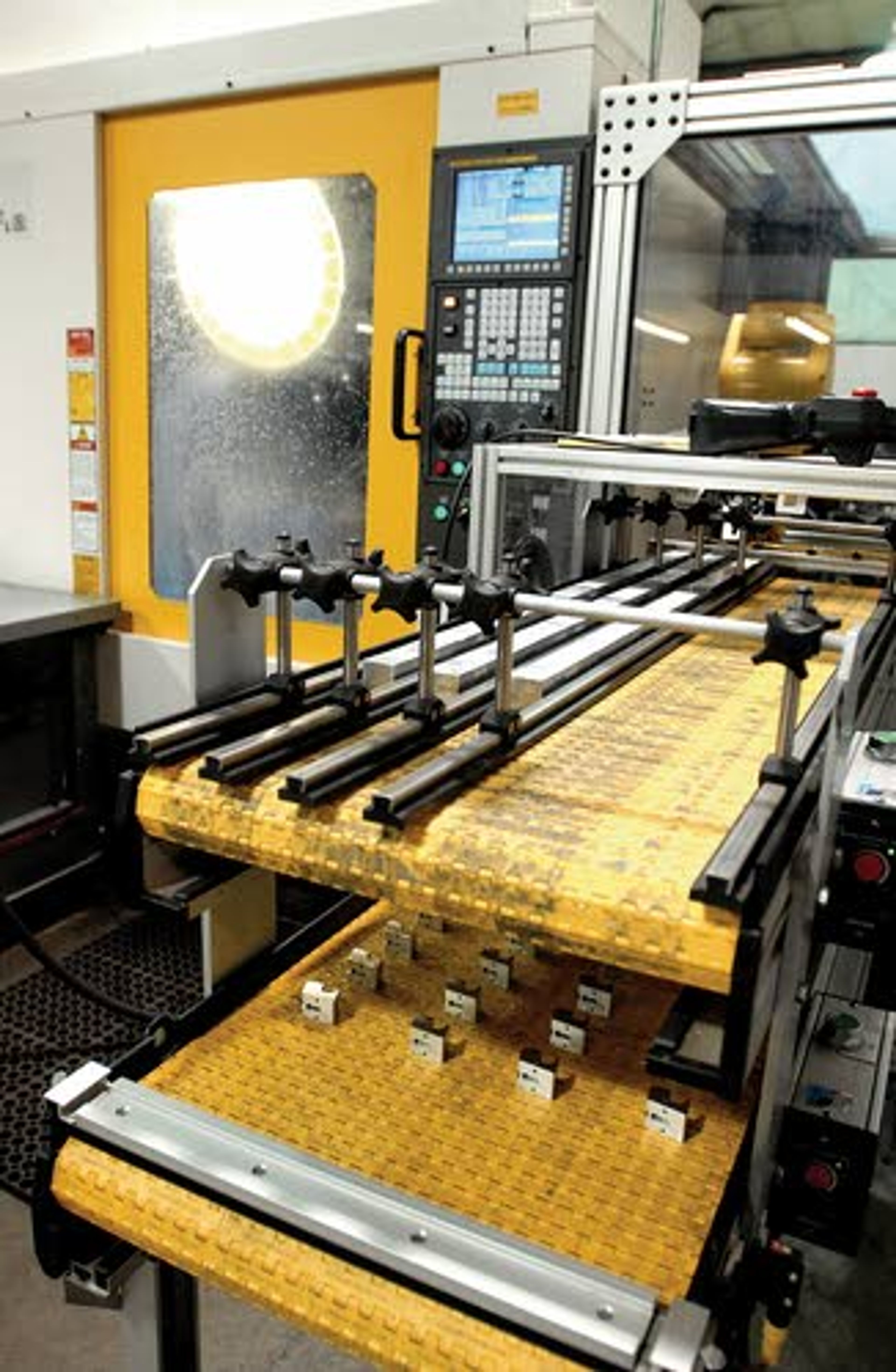 This computerized robot machine at Uhling Products Co. at Cottonwood picks up milled aluminum chunks and feeds them, one after another, all day long, into a water-cooled, multi-bit drilling machine that further shapes the metal into the basis of a medical equipment switch.