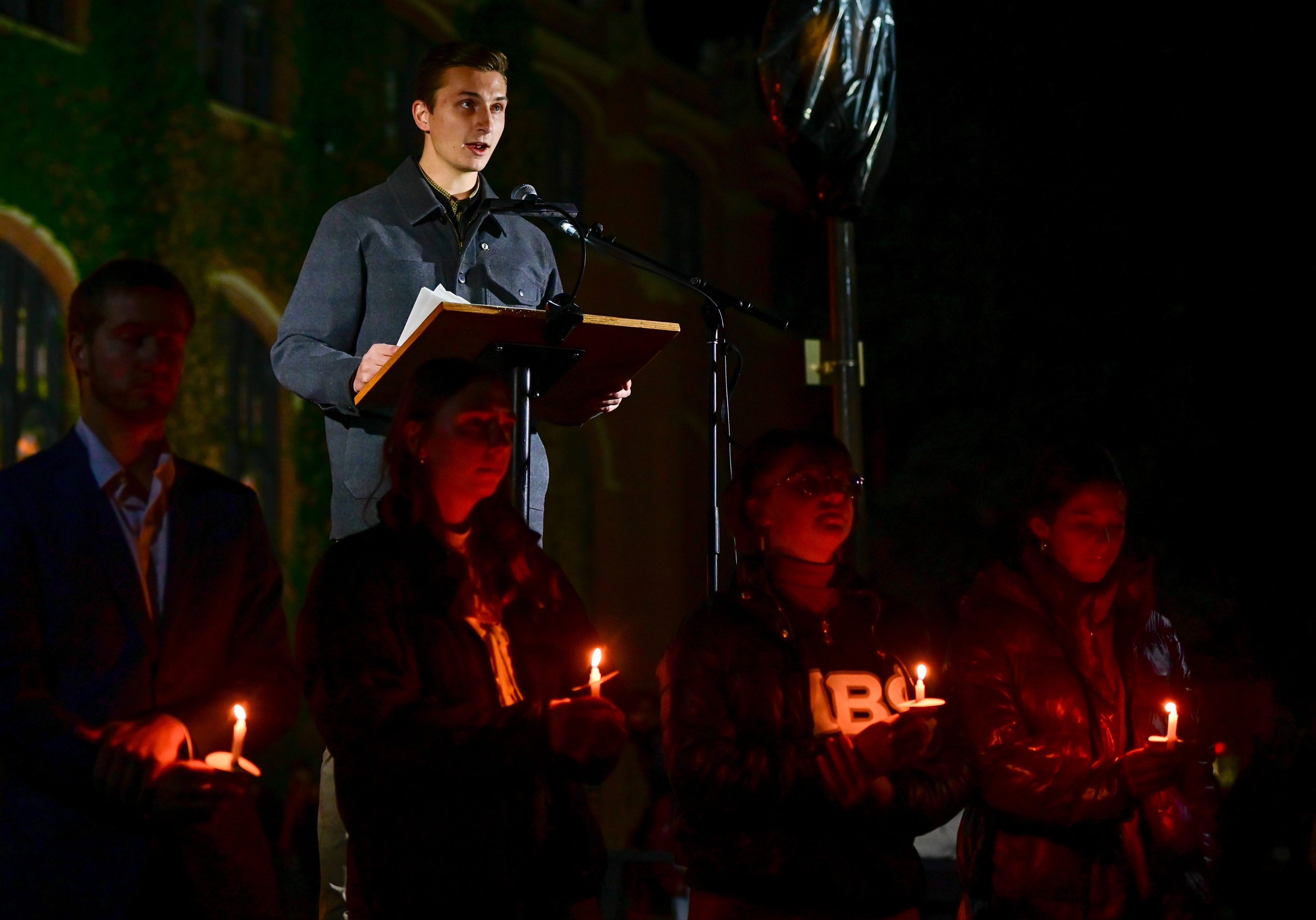 Tanner McClain, above, president of the Associated Students of the University of Idaho, welcomes those gathered on Monday for a vigil in honor of the four University of Idaho students killed a year ago in Moscow.