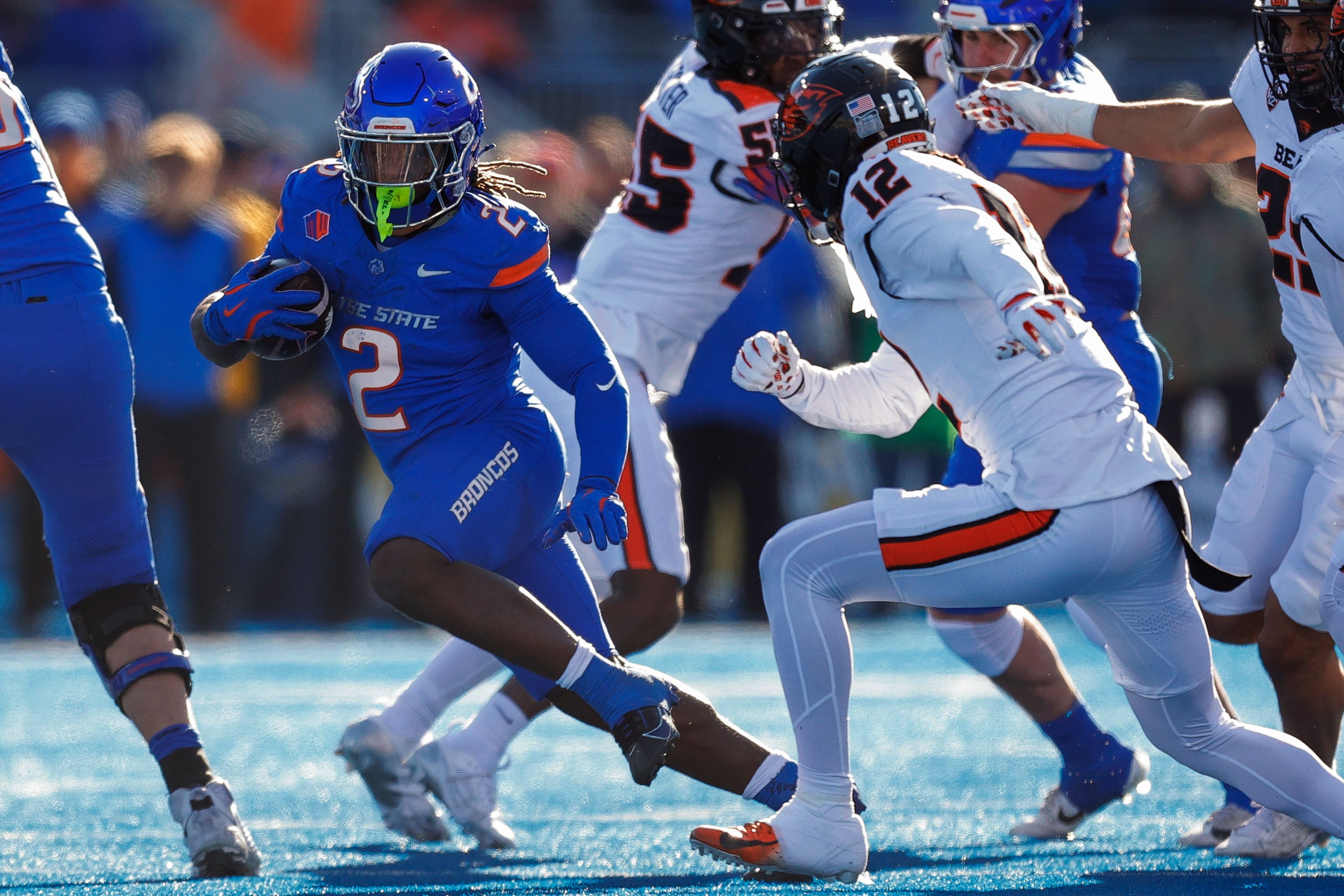 Boise State running back Ashton Jeanty (2) cuts away from Oregon State defensive back Tyrice Ivy Jr. (12) on a run in the first half of an NCAA college football game, Friday, Nov. 29, 2024, in Boise, Idaho. (AP Photo/Steve Conner)