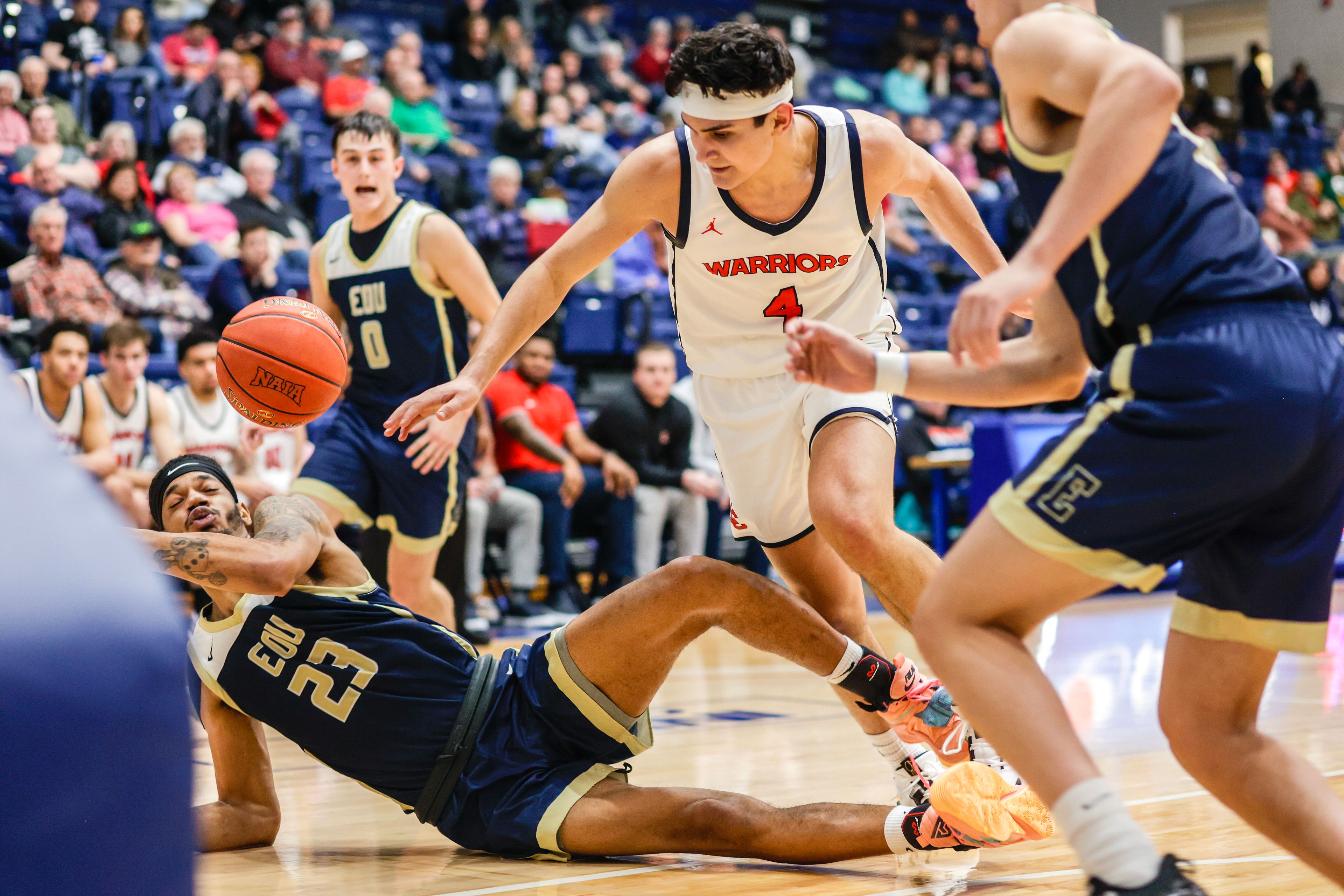 Eastern Oregon forward/center Ismael Valdez hits the ground as Lewis-Clark State guard Silas Bennion, center, tries to grab a loose ball during Friday’s Cascade Conference game at the P1FCU Activity Center.