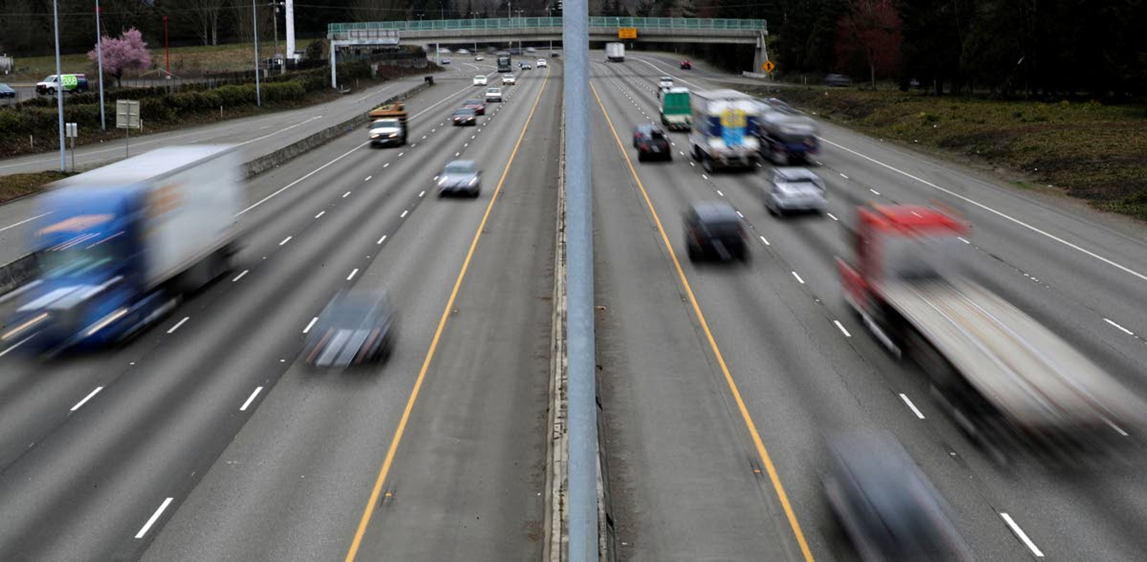 Cars and trucks travel on Interstate Highway 5 near Olympia, Wash., Monday, March 25, 2019. Democrats in the Washington House released their two-year transportation budget proposal Monday, which includes $9.9 billion in spending for projects. (AP Photo/Ted S. Warren)