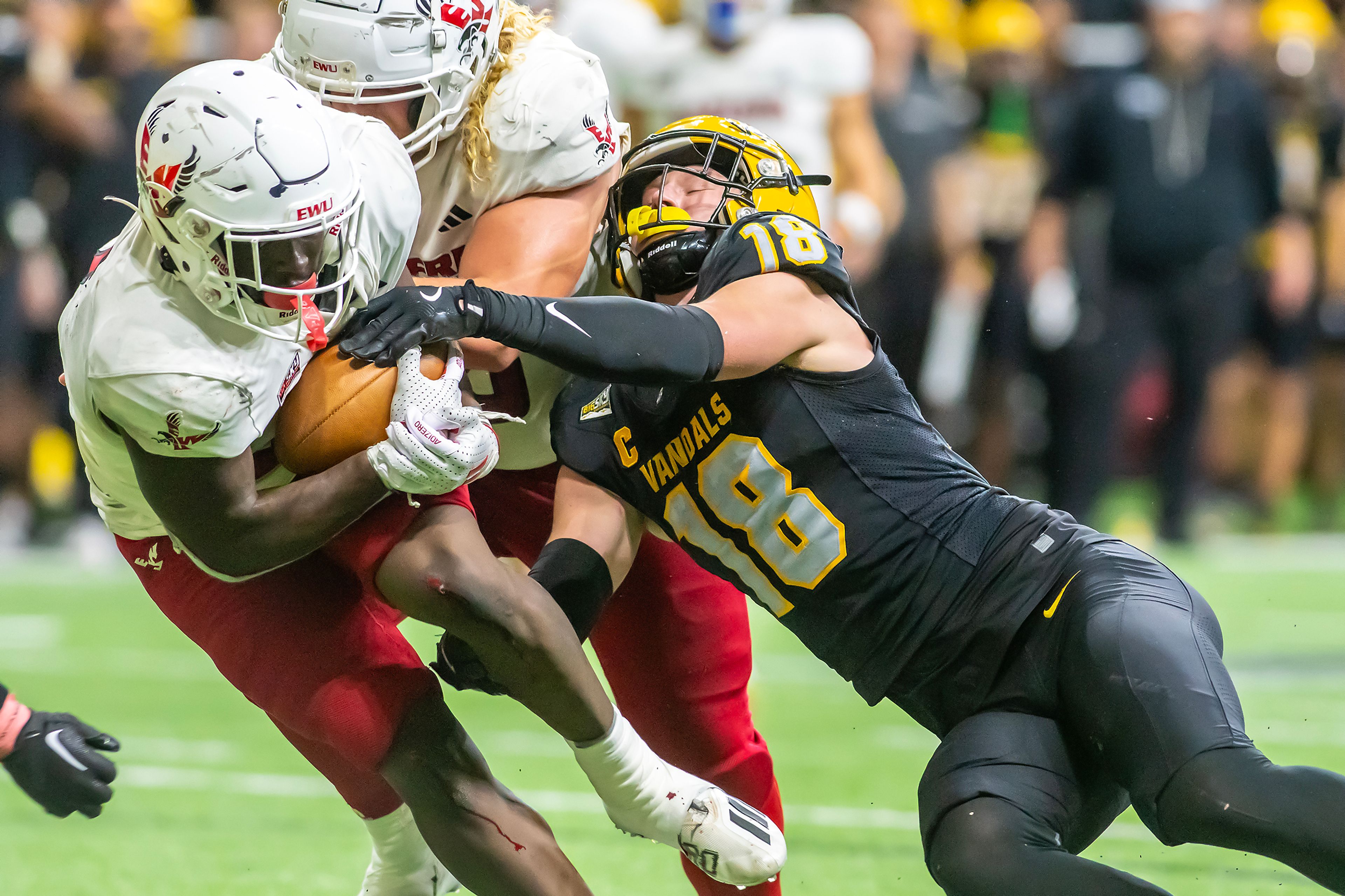 Idaho defensive back Tommy McCormick tackles Eastern Washington running back Tuna Altahir during a Big Sky game Saturday at the Kibbie Dome in Moscow. 