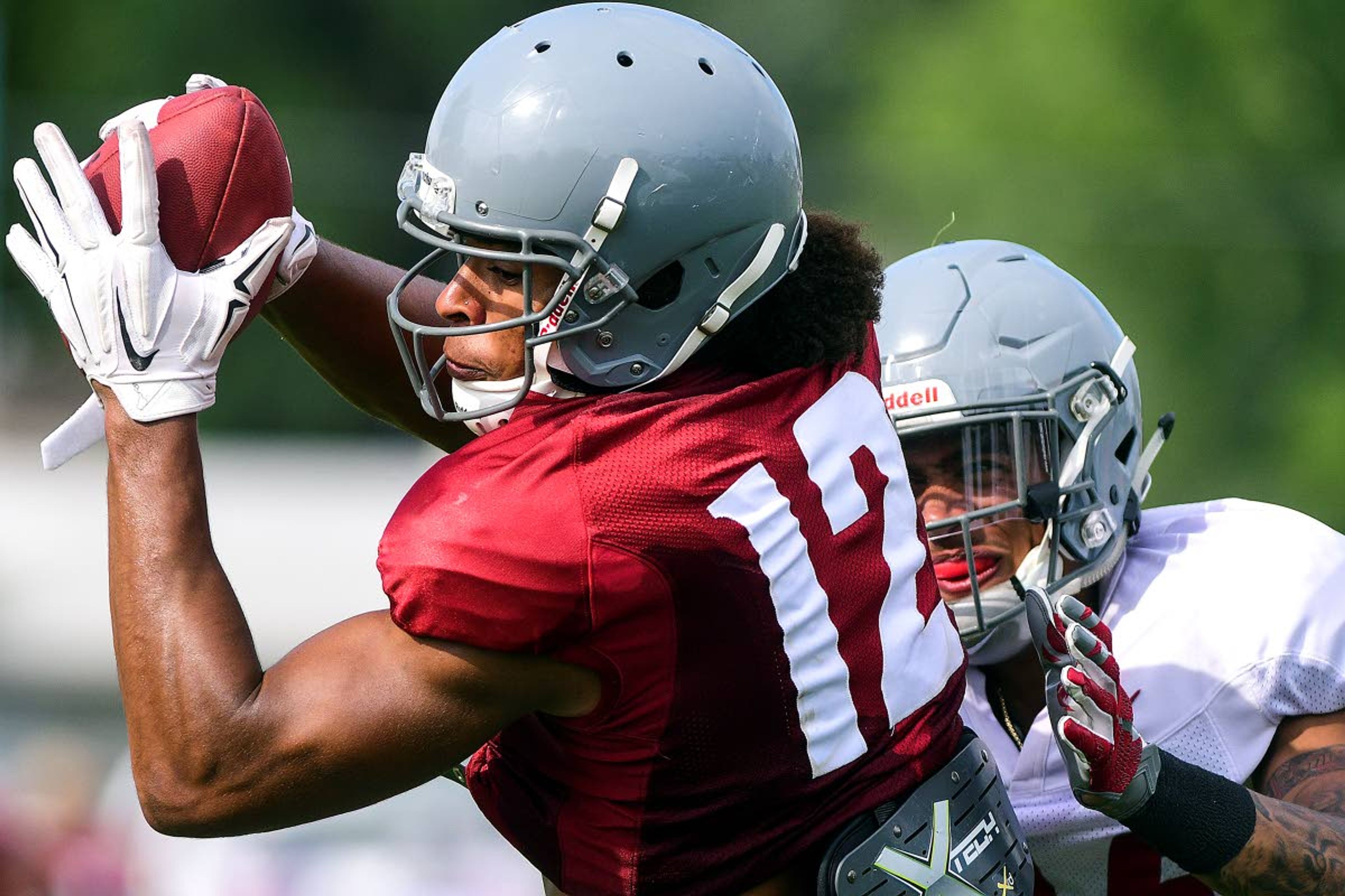 Tribune/Pete CasterWashington State receiver Dezmon Patmon catches a pass as defensive back Shahman Moore defends during team drills Tuesday in Lewiston.