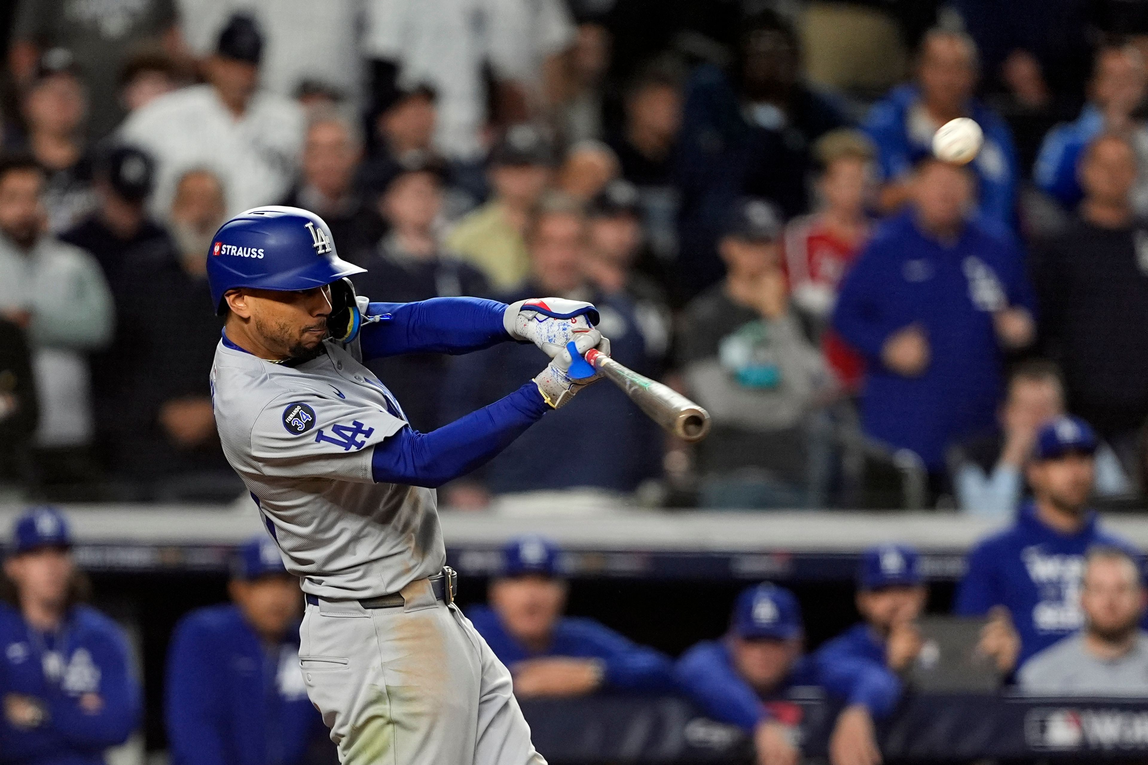 Los Angeles Dodgers' Mookie Betts hits a sacrifice fly against the New York Yankees during the eighth inning in Game 5 of the baseball World Series, Wednesday, Oct. 30, 2024, in New York. (AP Photo/Godofredo A. VÃ¡squez)