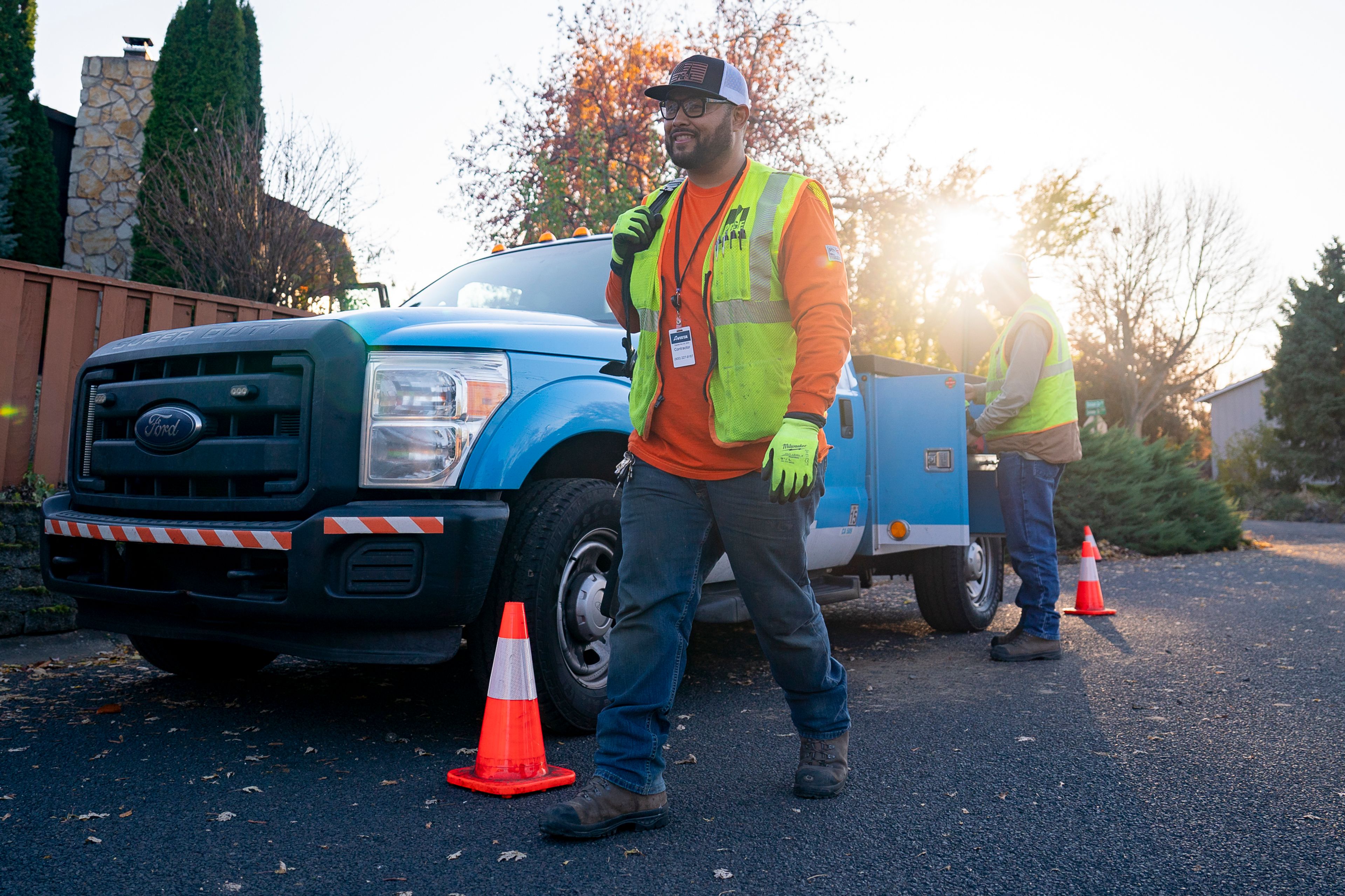 Pacific Gas and Electric gas service representative Joseph Williams, left, Concord, CA., walks over to greet a homeowner before lighting their furnace on Tuesday in Lewiston.