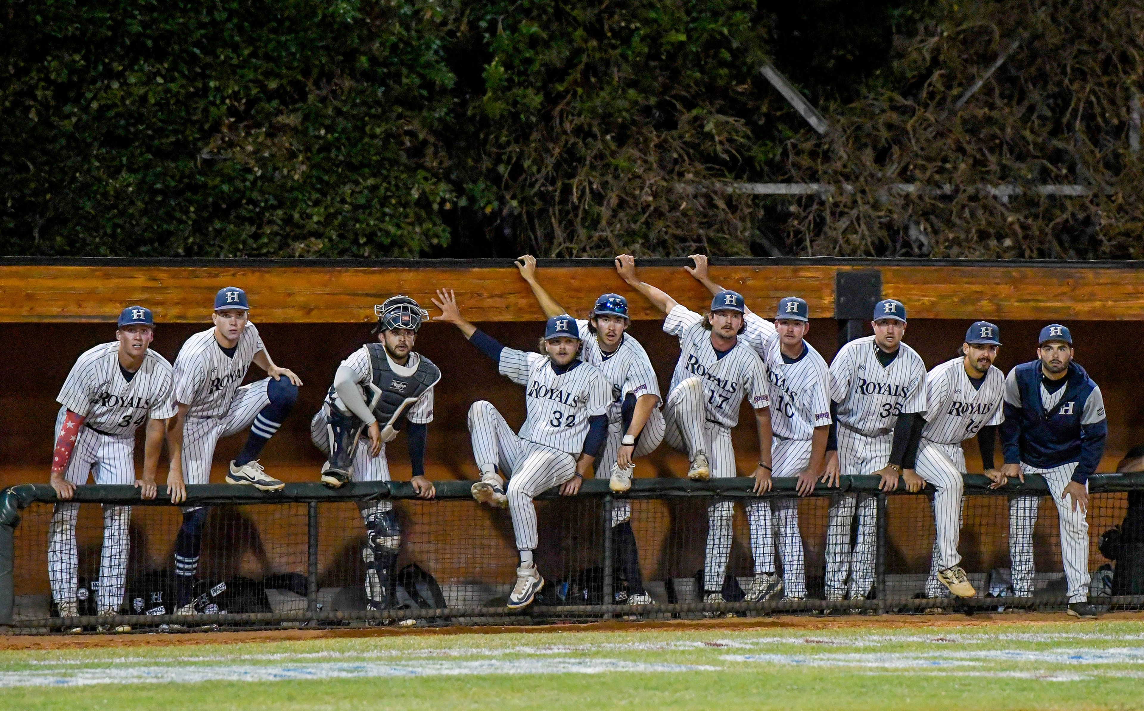 Hope International players ready themselves to rush the field in the final inning against Tennessee Wesleyan in the championship game of the NAIA World Series at Harris Field in Lewiston on Friday.