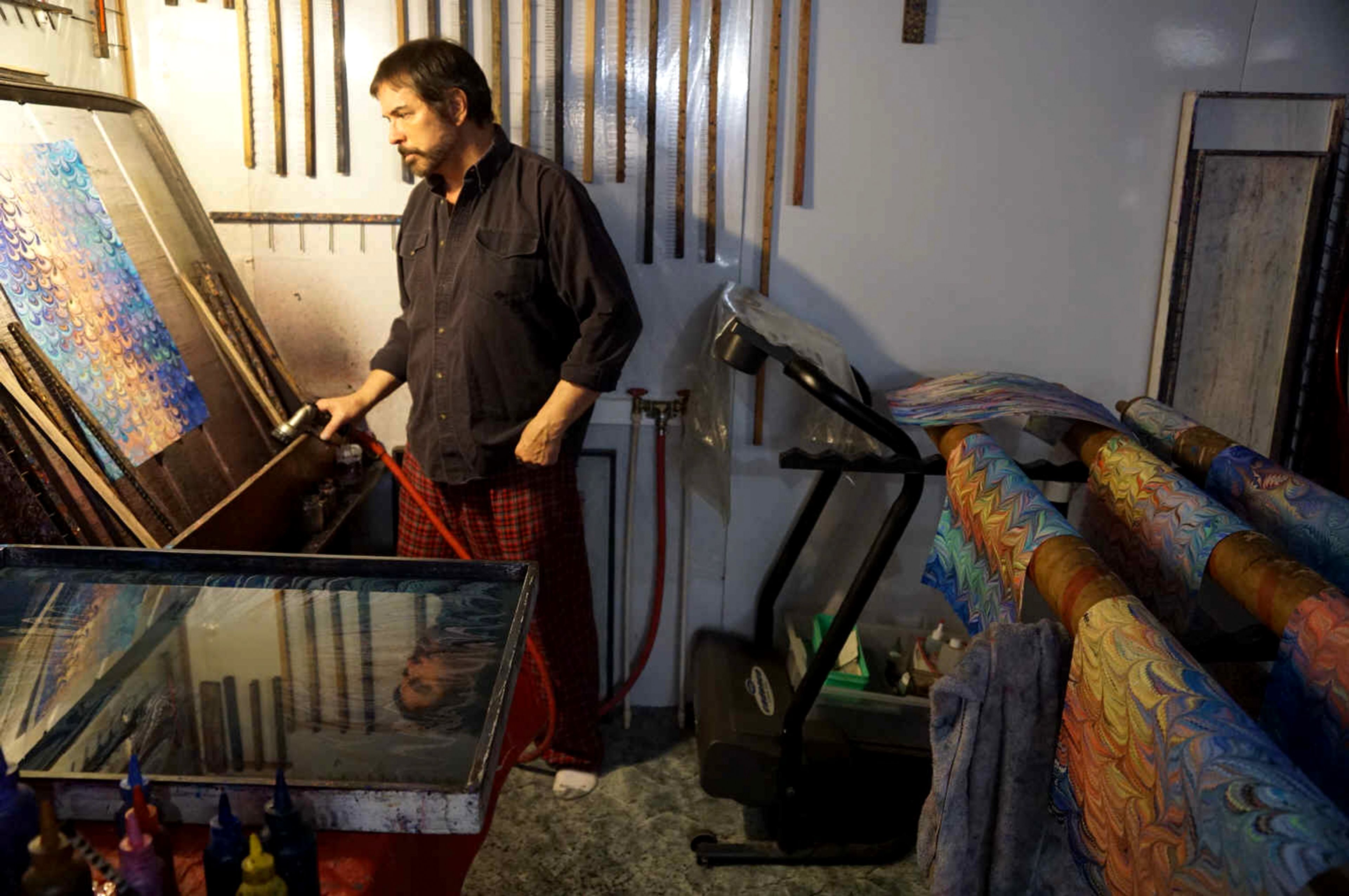 Galen Berry works on rinsing in his marbling studio.