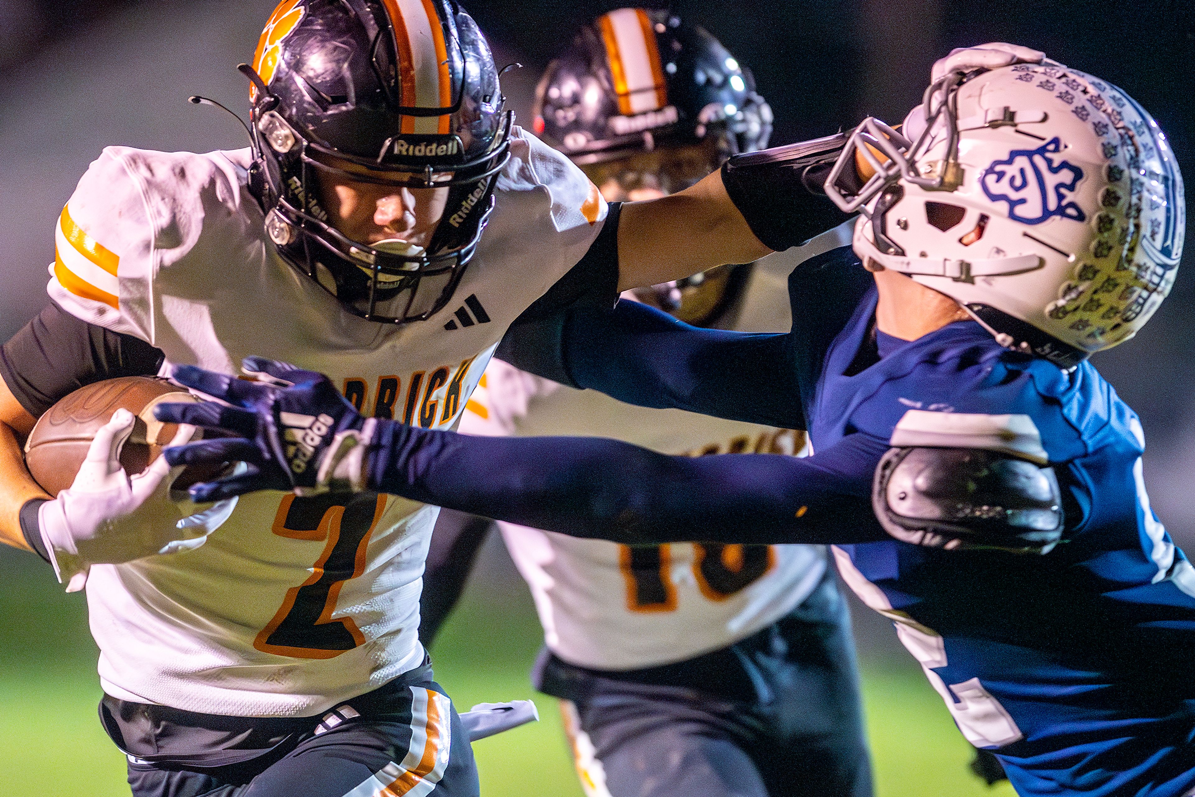 Kendrick wide receiver Ralli Roetcisoender stiff arms a Logos player in a semifinal game of the Idaho State Football Class 2A Championships Friday at Bengal Field in Lewiston.