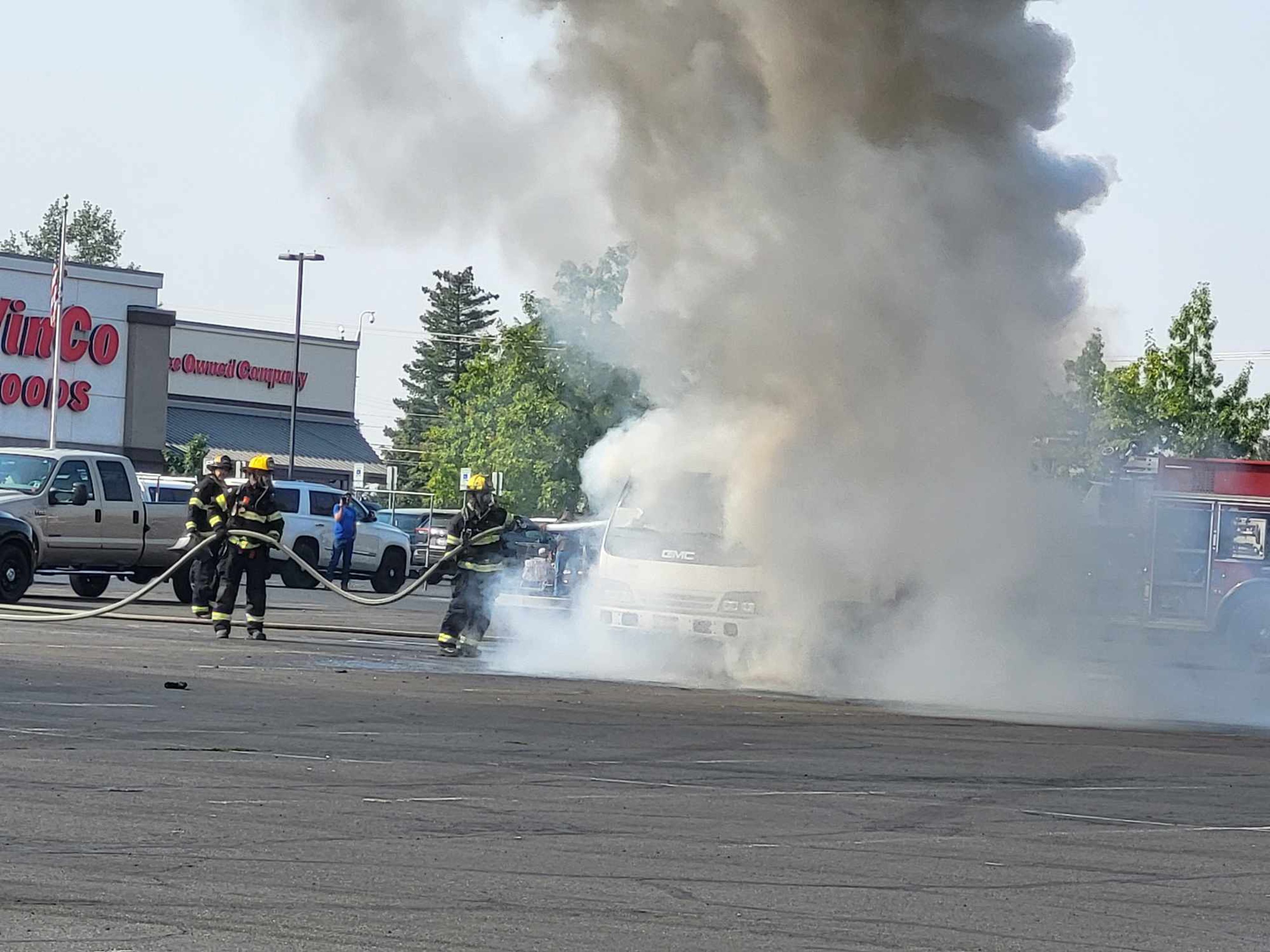 Firefighters hose down a vehicle that caught on fire Saturday morning at the Lewiston Central Mall.