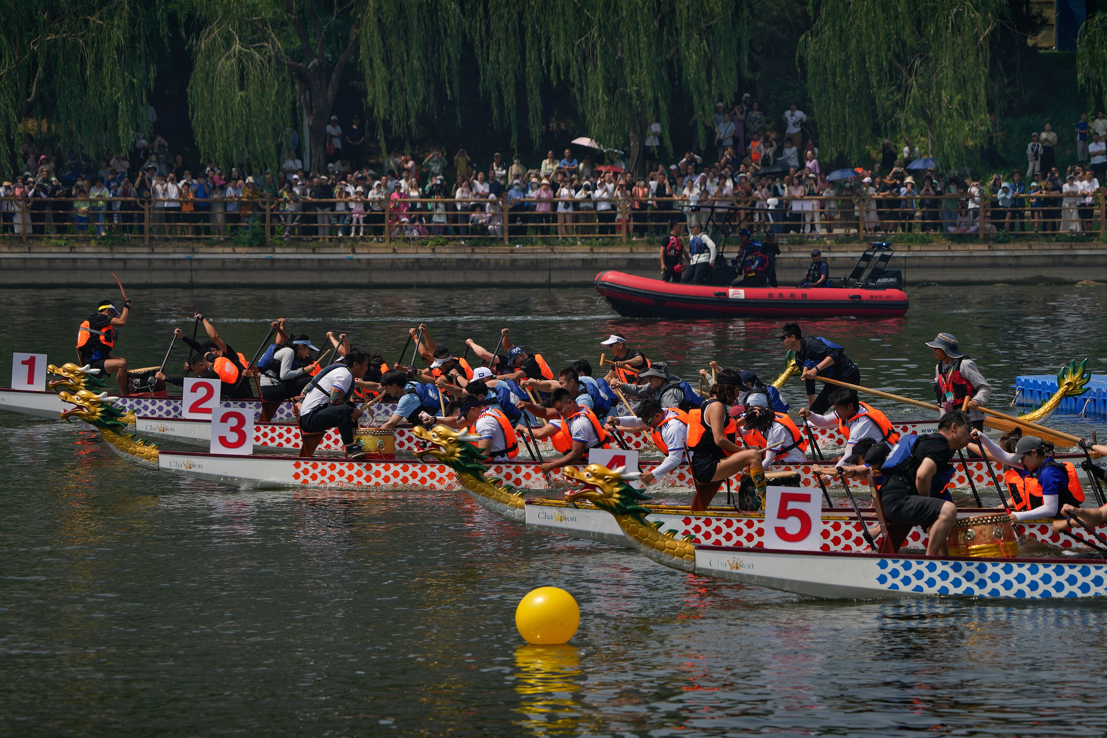 Teams of dragon boat racers paddle their boats as they compete in the Dragon Boat festival at a canal in Tongzhou, on the outskirts of Beijing, Monday, June 10, 2024. The Duanwu festival, also known as the Dragon Boat festival, falls on the fifth day of the fifth month of the Chinese lunar calendar and is marked by celebrations like eating rice dumplings and racing dragon boats.