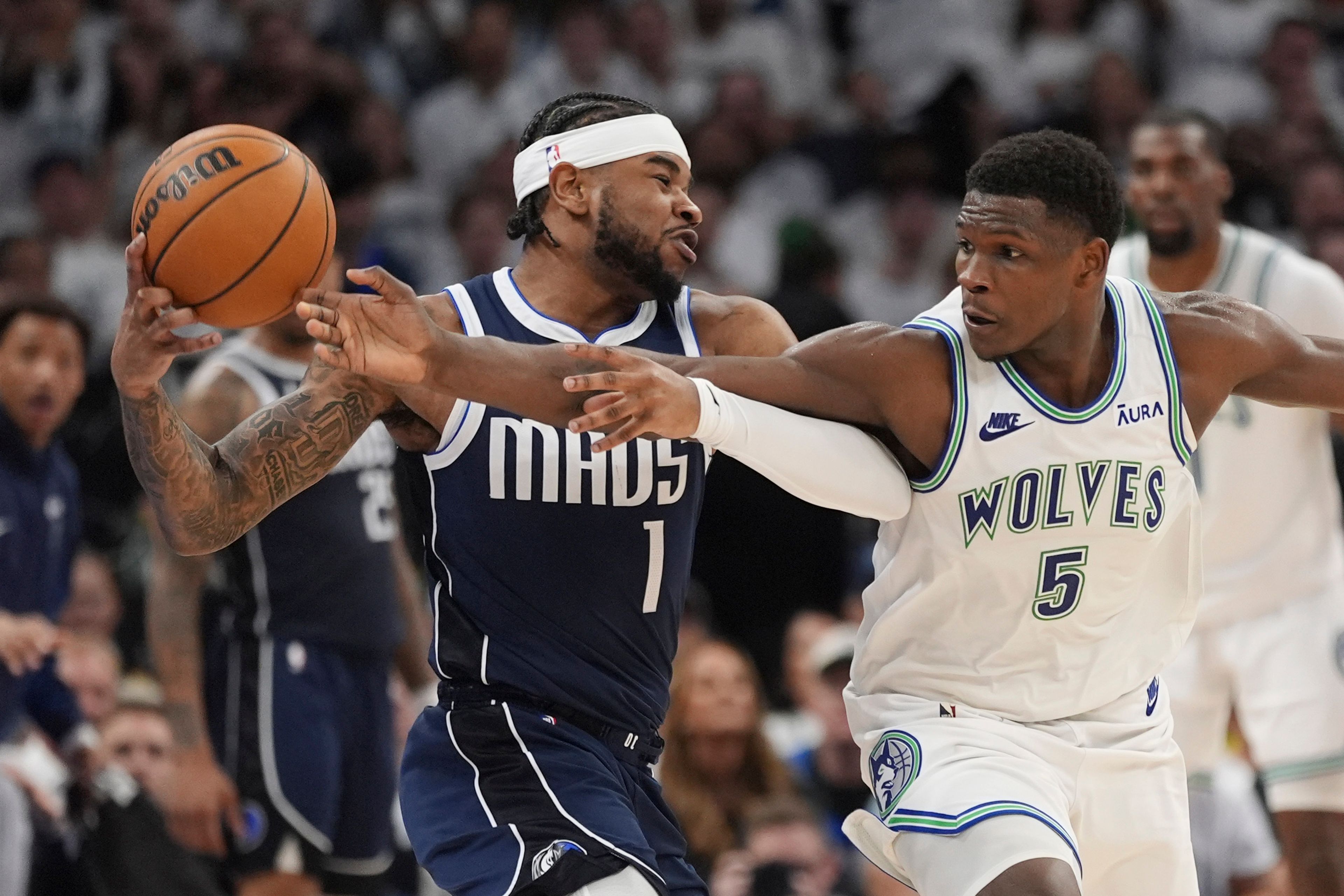 Mavericks guard Jaden Hardy, left, is defended by Timberwolves guard Anthony Edwards, right, during the second half in Game 1 of the Western Conference finals Wednesdayin Minneapolis.