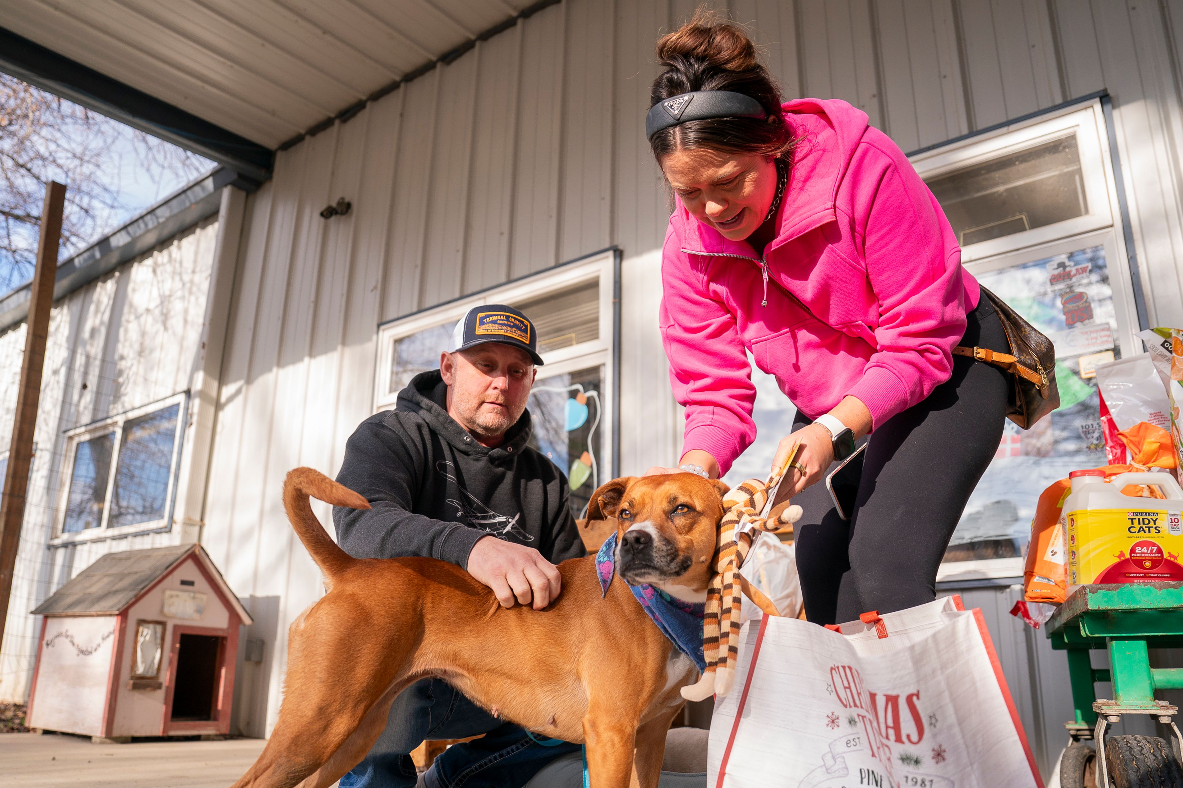 Little Girl the dog receives pets and toys from Rich and Jen Casey on Friday at Lewis Clark Animal Shelter in Lewiston.