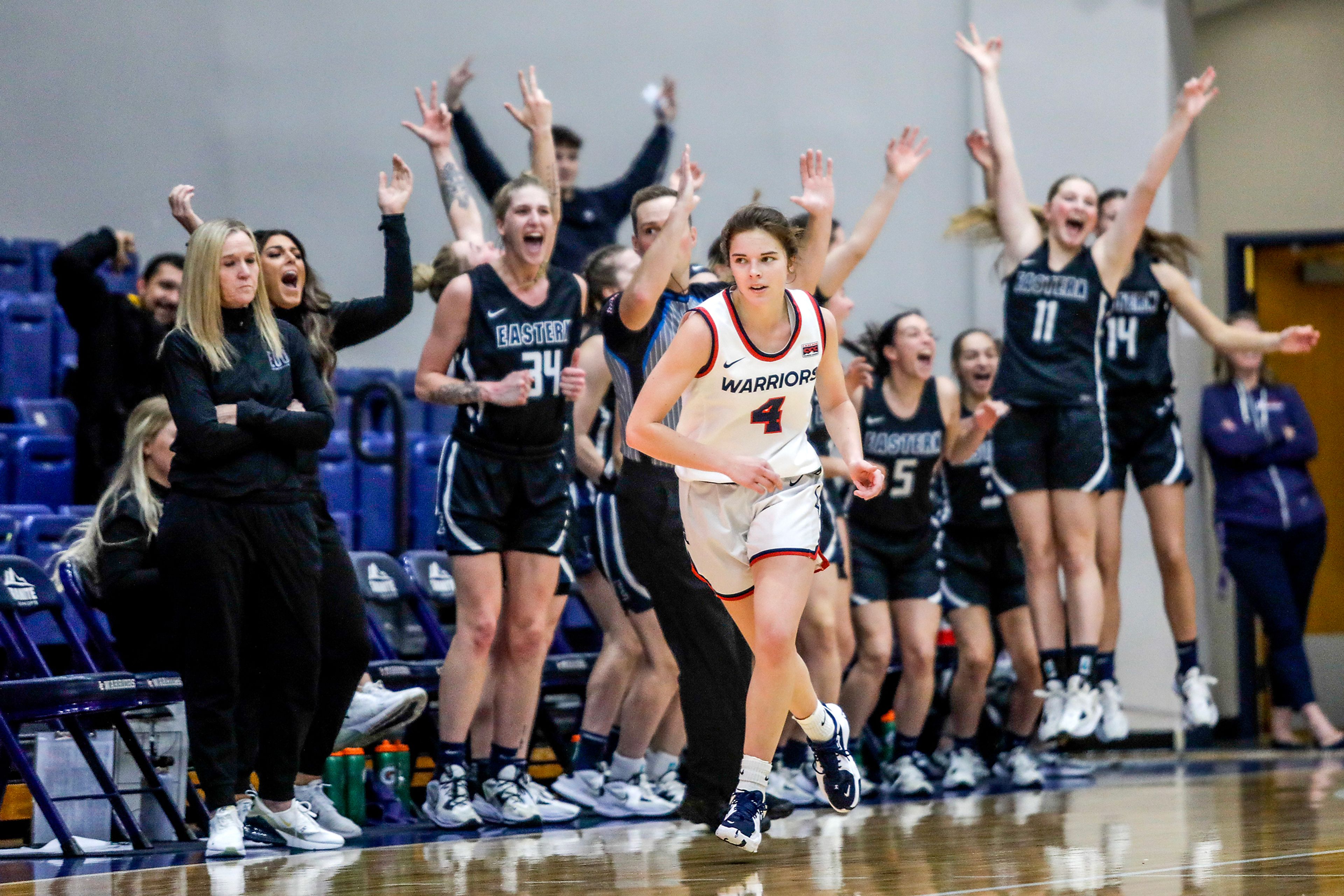 Lewis-Clark State guard Ellie Sander runs down the court as the Eastern Oregon bench celebrates a 3-pointer during a Cascade Conference game Friday at Lewis-Clark State College.