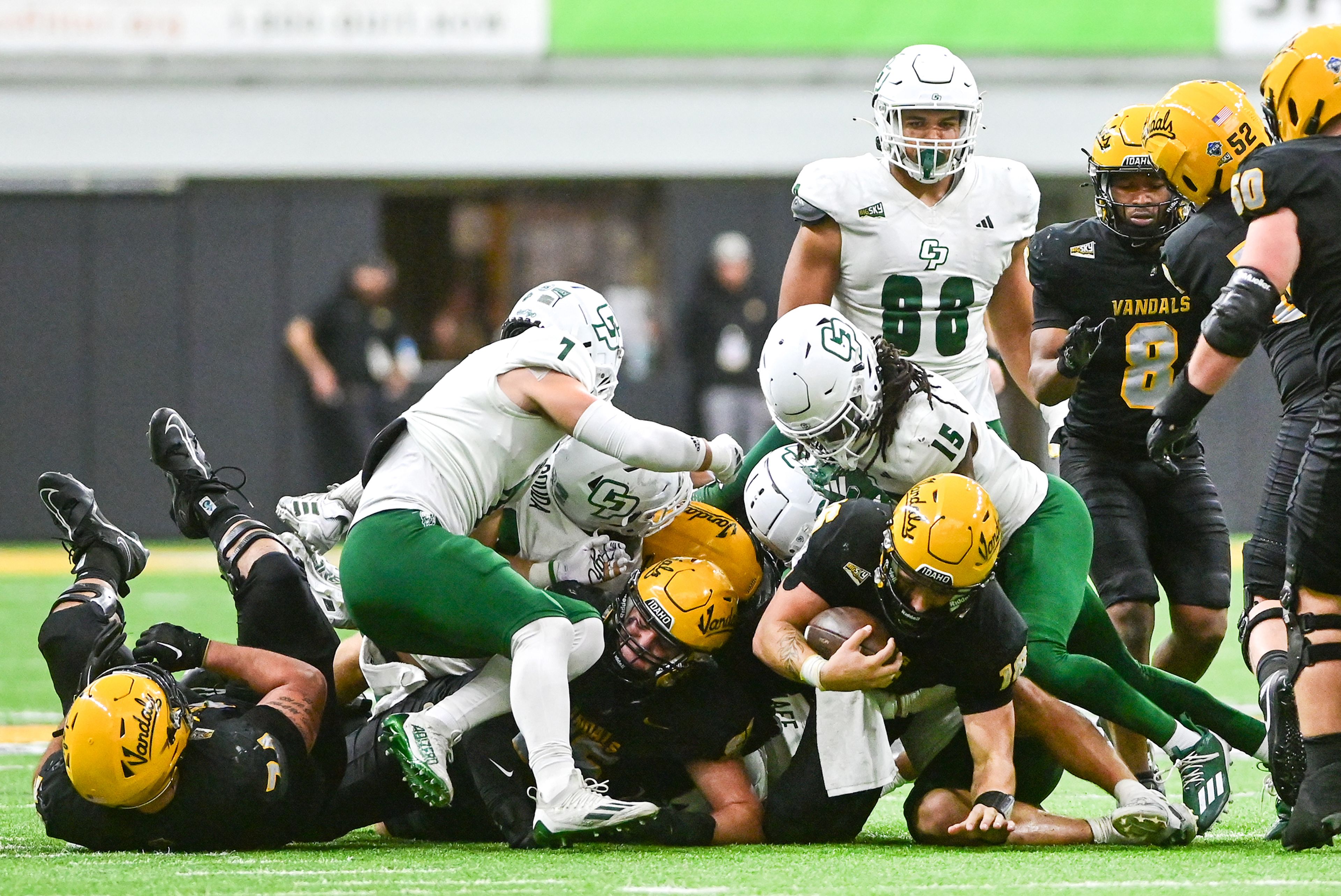 Idaho quarterback Rocco Koch is tackled by a crowd of Cal Poly defenders Saturday at the P1FCU Kibbie Dome in Moscow.,