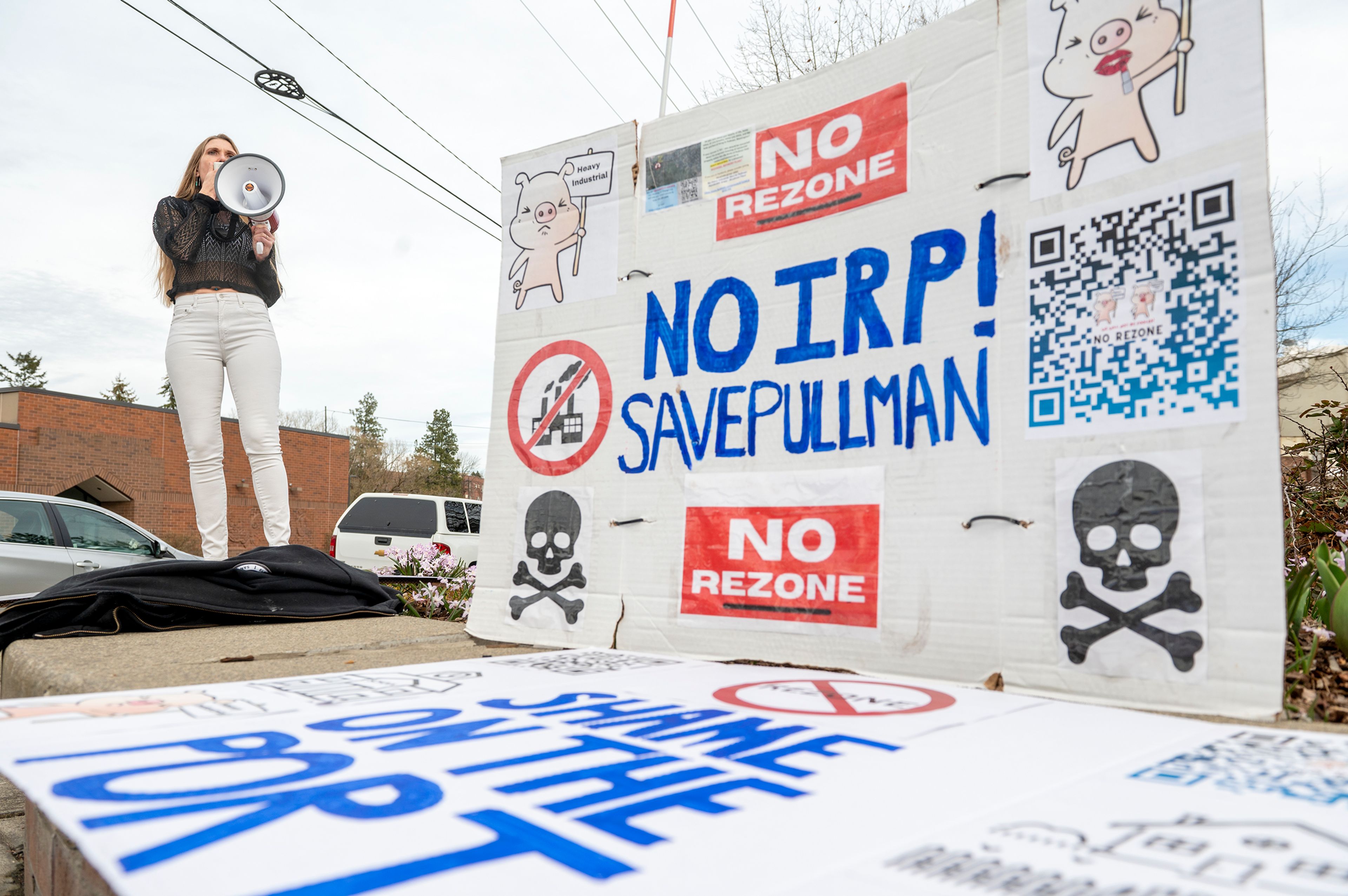 Janelle Sordelet leads a chant in the Cougar Plaza during a protest Monday against the Port of Whitman’s decision to rezone on a residential property next to Whispering Hills neighborhood in Pullman.