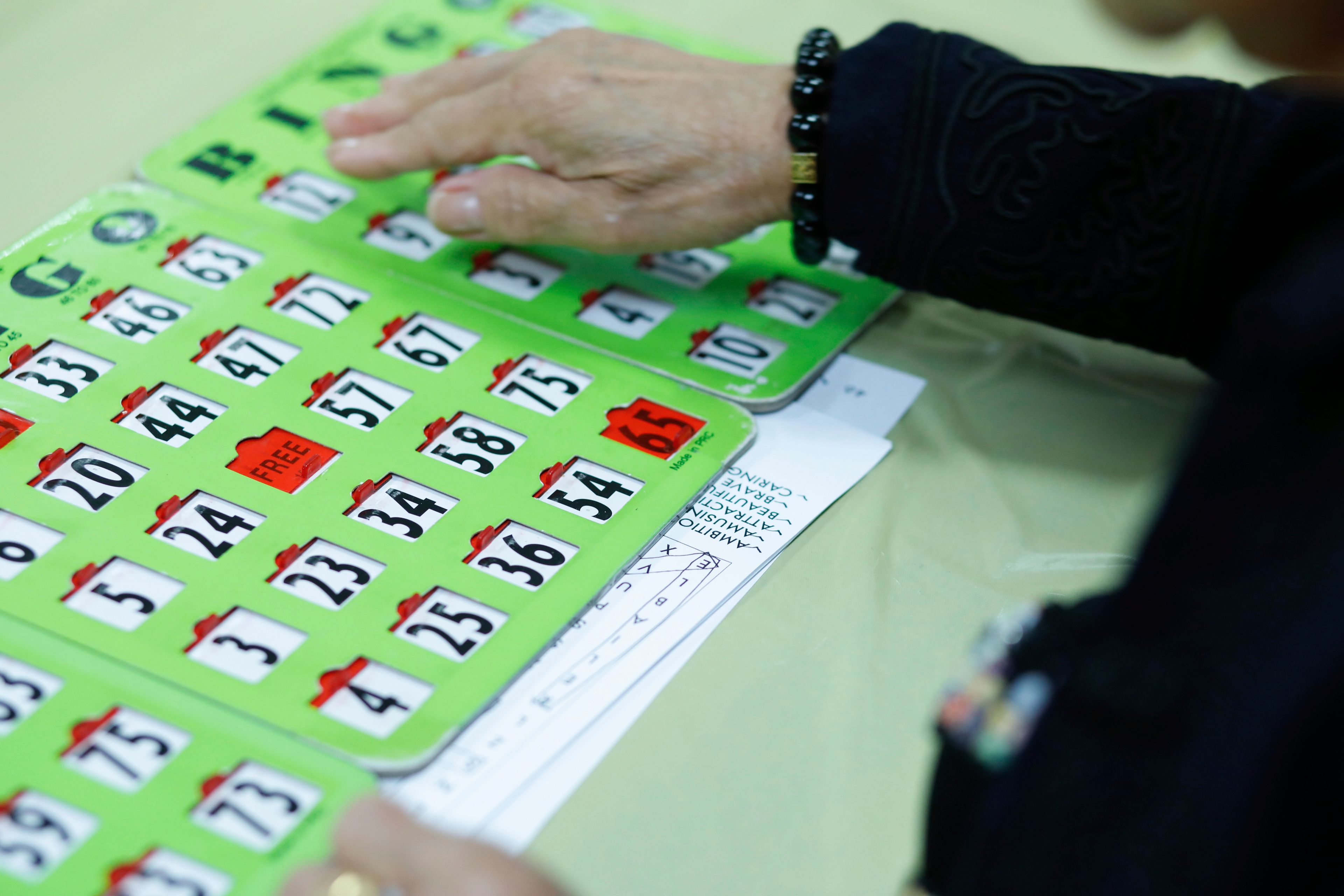 A woman plays Bingo at Sunshine Adult Day Center in Bergenfield, N.J., Monday, Aug. 26, 2024. (AP Photo/Kena Betancur),