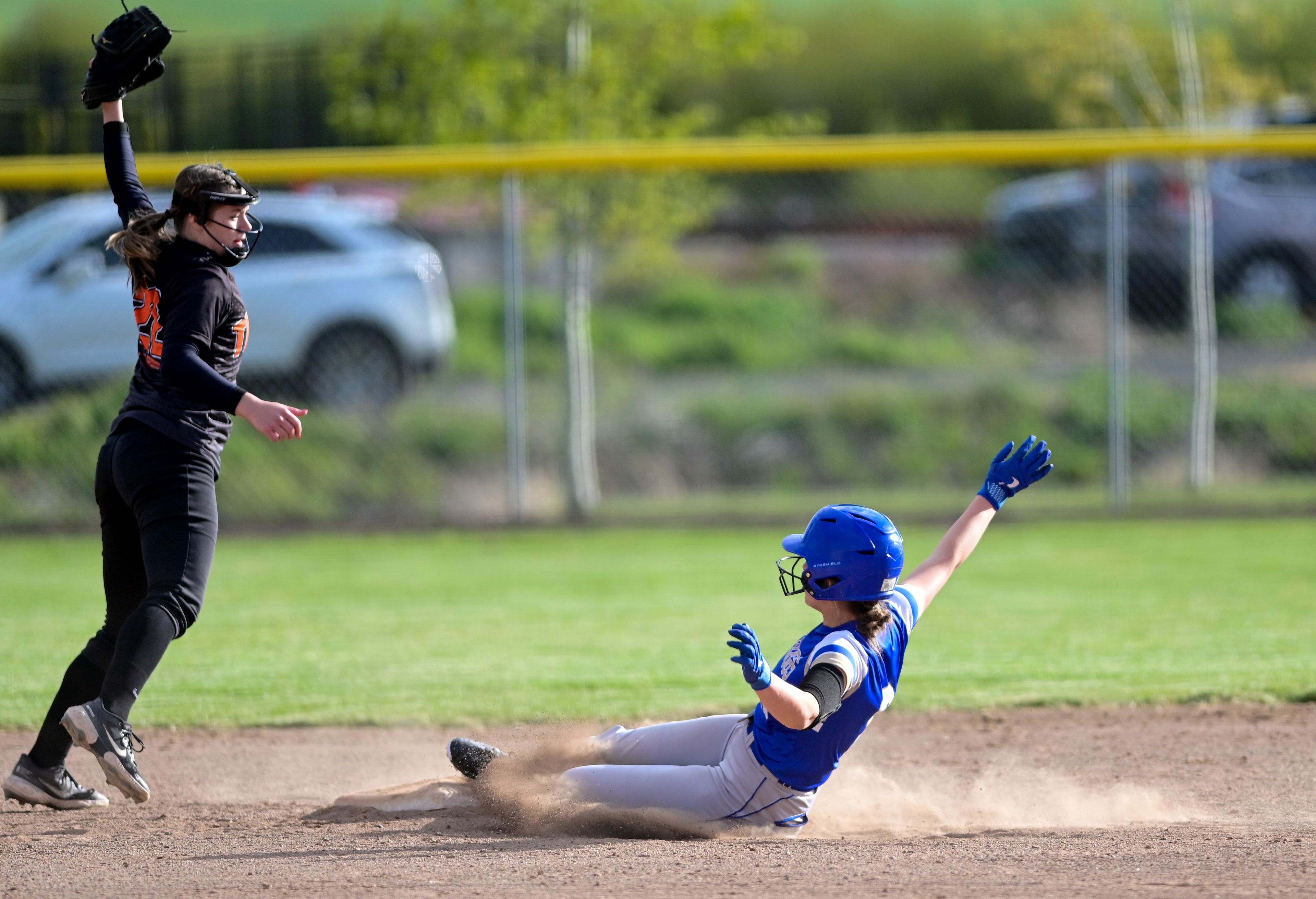 Kendrick’s Hailey Taylor reaches to try to make a catch as Genesee’s Mia Scharnhorst slides into third base during an Idaho 2A district tournament championship game Wednesday in Genesee.