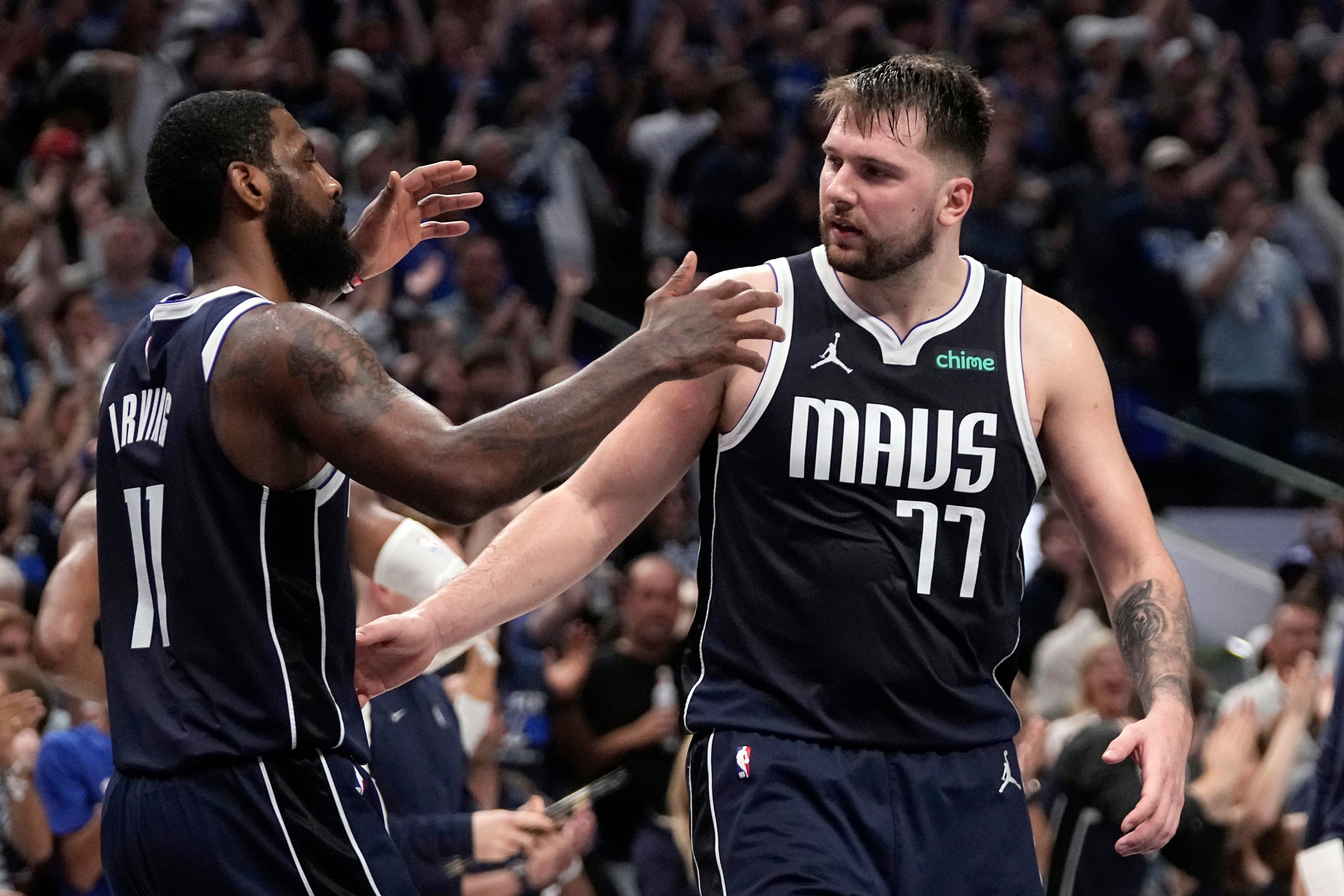 Dallas Mavericks' Kyrie Irving (11) and Luka Doncic, right, celebrate the team's win in Game 3 of an NBA basketball second-round playoff series against the Oklahoma City Thunder, Saturday, May 11, 2024, in Dallas. (AP Photo/Tony Gutierrez)