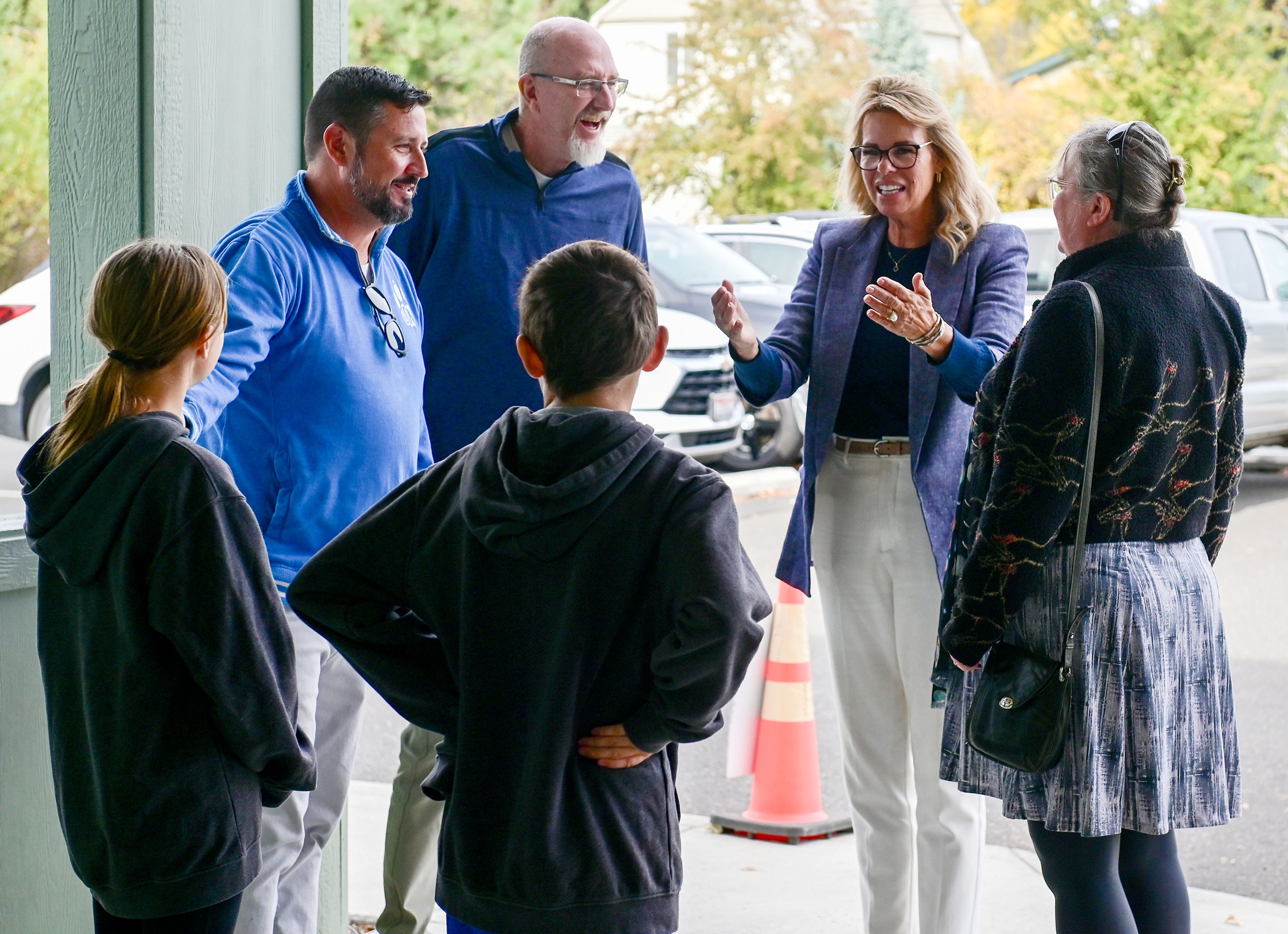 Idaho Superintendent of Public Instruction Debbie Critchfield, back right, and husband Dave Critchfield, back center, are welcomed to Moscow Charter School by students Quinn Rokyta, front left, and Gavin Bonuccelli, front center, principal Tony Bonuccelli, back left, and school board of directors chairperson Leslie Baker, front right, Friday in Moscow.