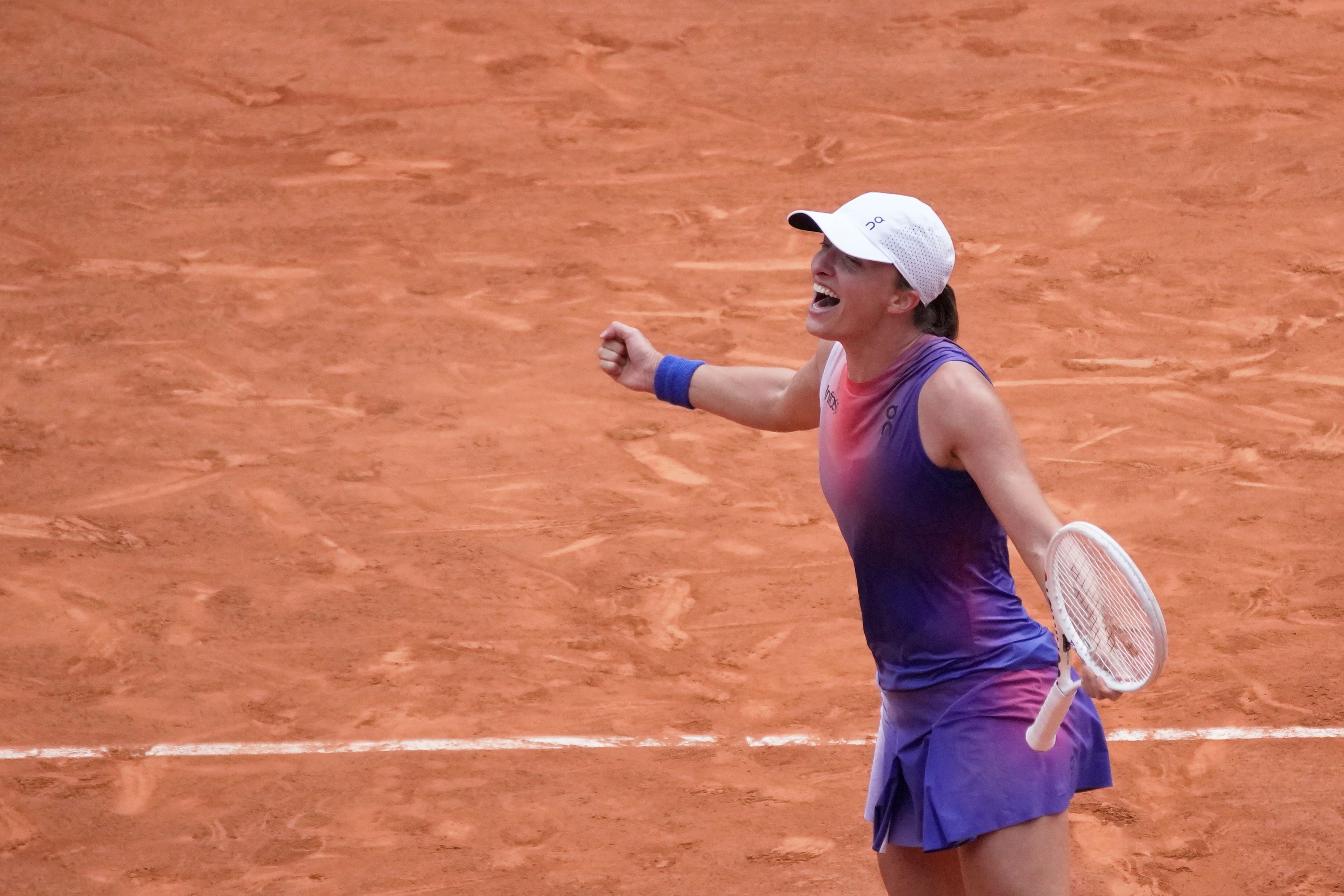 Poland's Iga Swiatek celebrates as she won the women's final of the French Open tennis tournament against Italy's Jasmine Paolini at the Roland Garros stadium in Paris, France, Saturday, June 8, 2024.