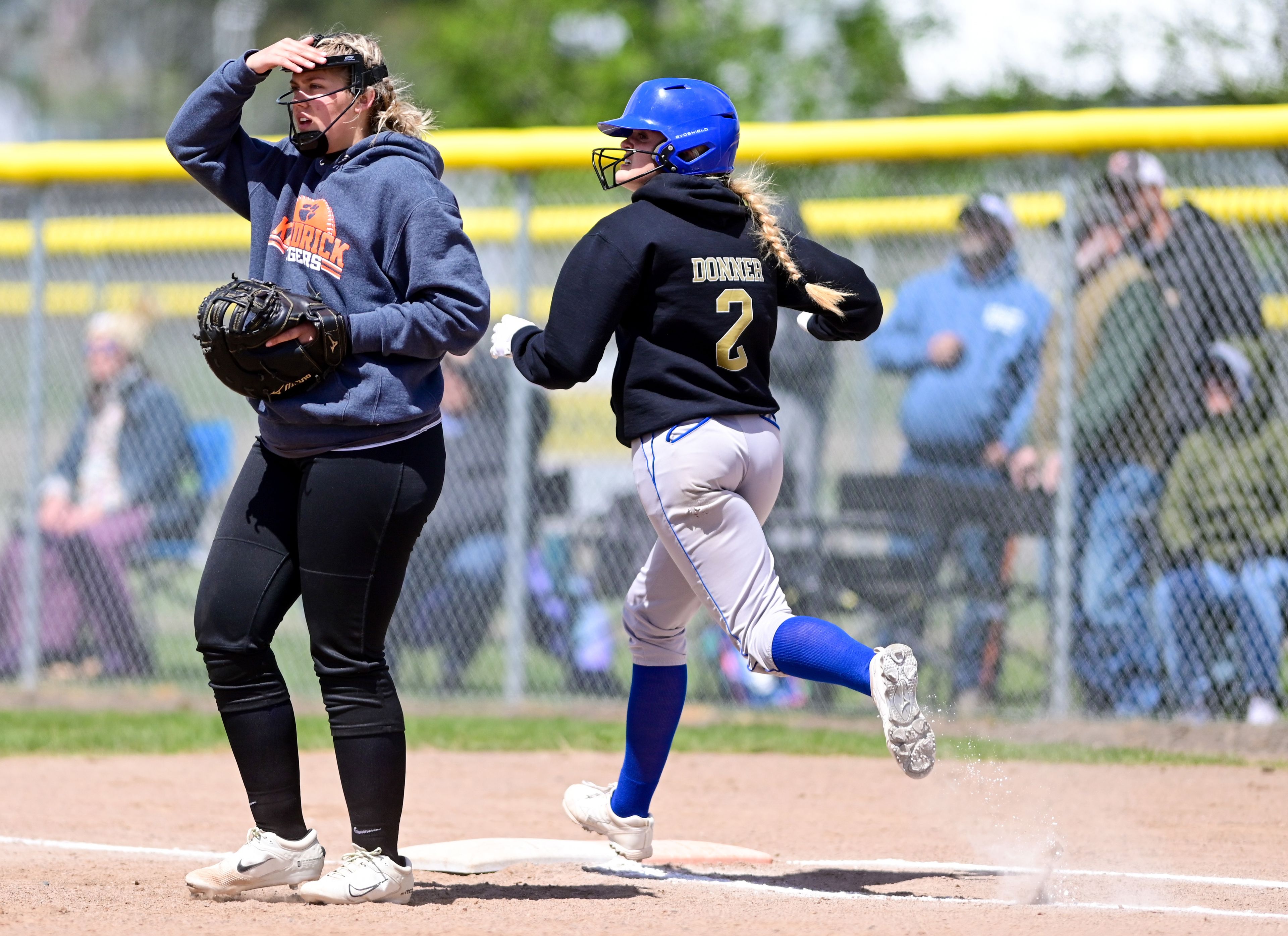 Kendrick’s Taylor Boyer looks as Genesee’s Harlei Donner runs to first base during an Idaho Class 1A state championship game Friday in Genesee.