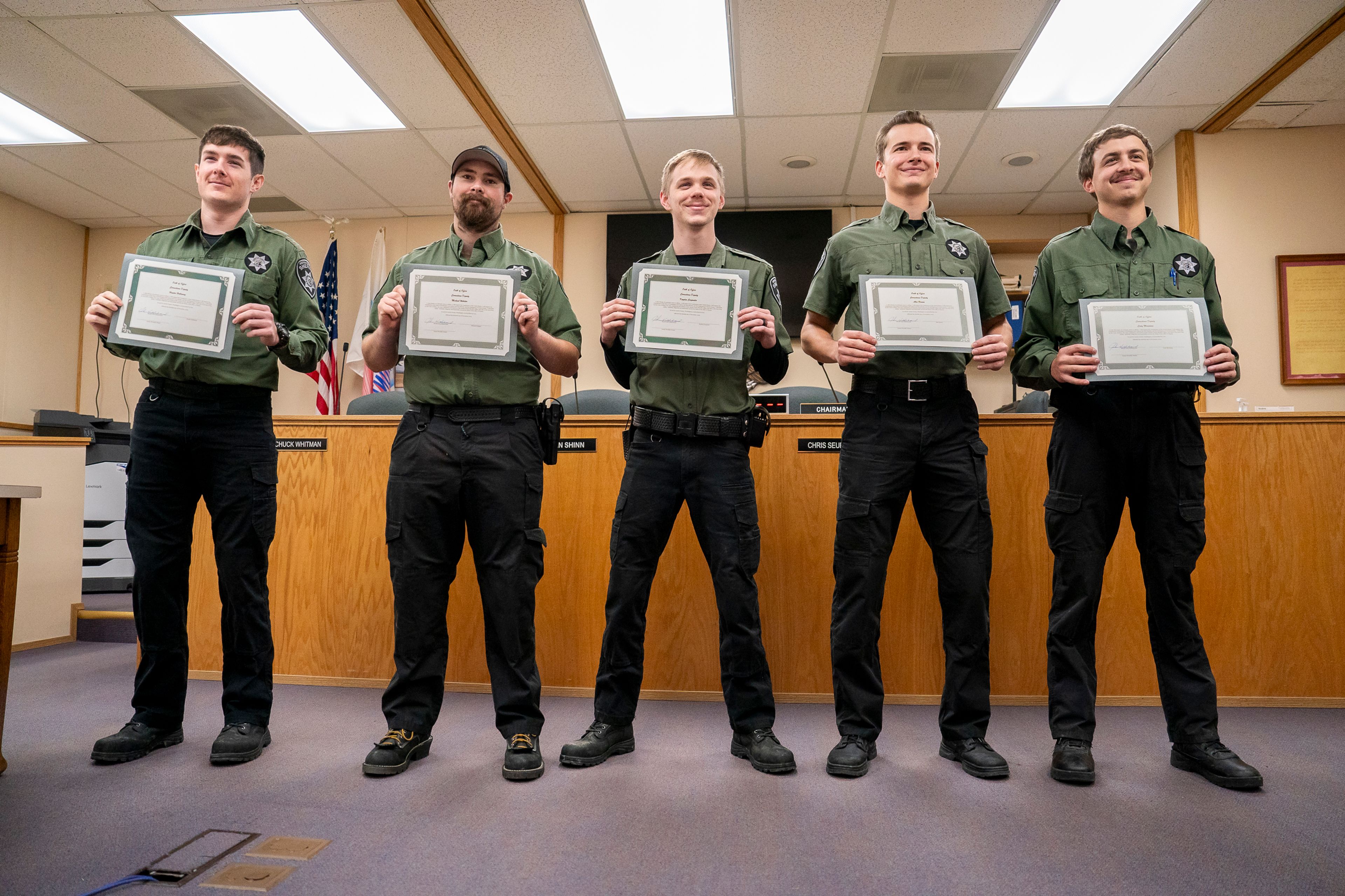 From left: Hunter Holloway, Michael Webster, Kayden Carpenter, Alex Hamm and Cody Moosman pose for a photo holding their certificates as newly sworn in corrections deputies on Thursday afternoon inside the Asotin County Courthouse Annex.