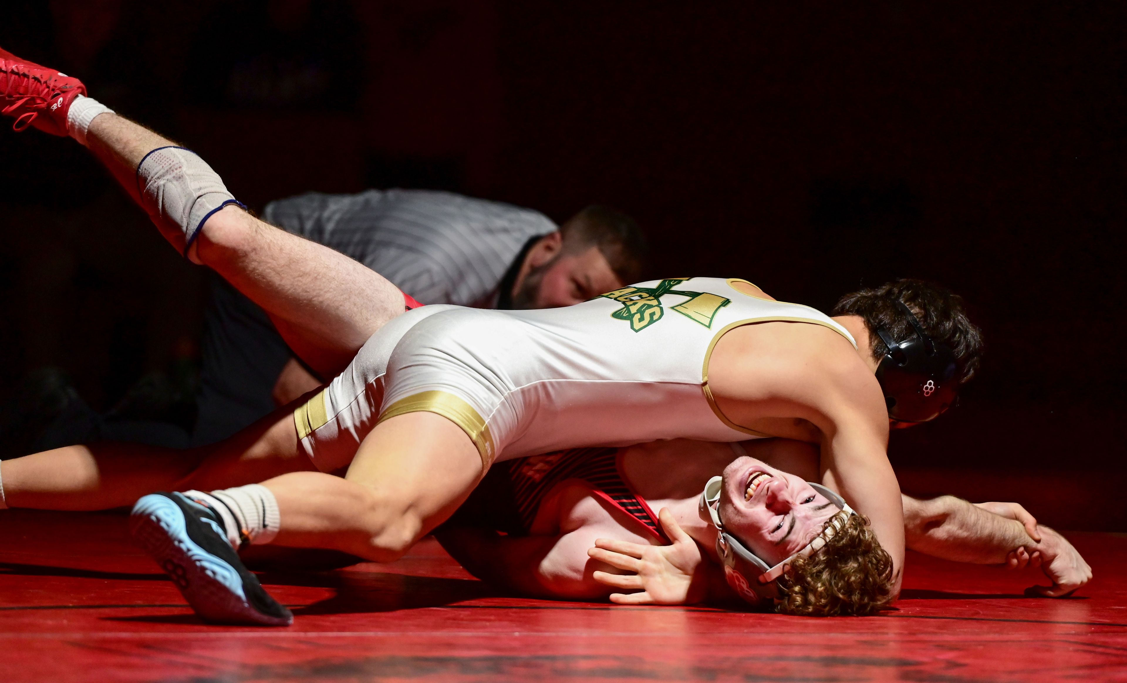 Moscow’s Sam Young raises a leg while being pinned during a match Thursday at Bear Den in Moscow.