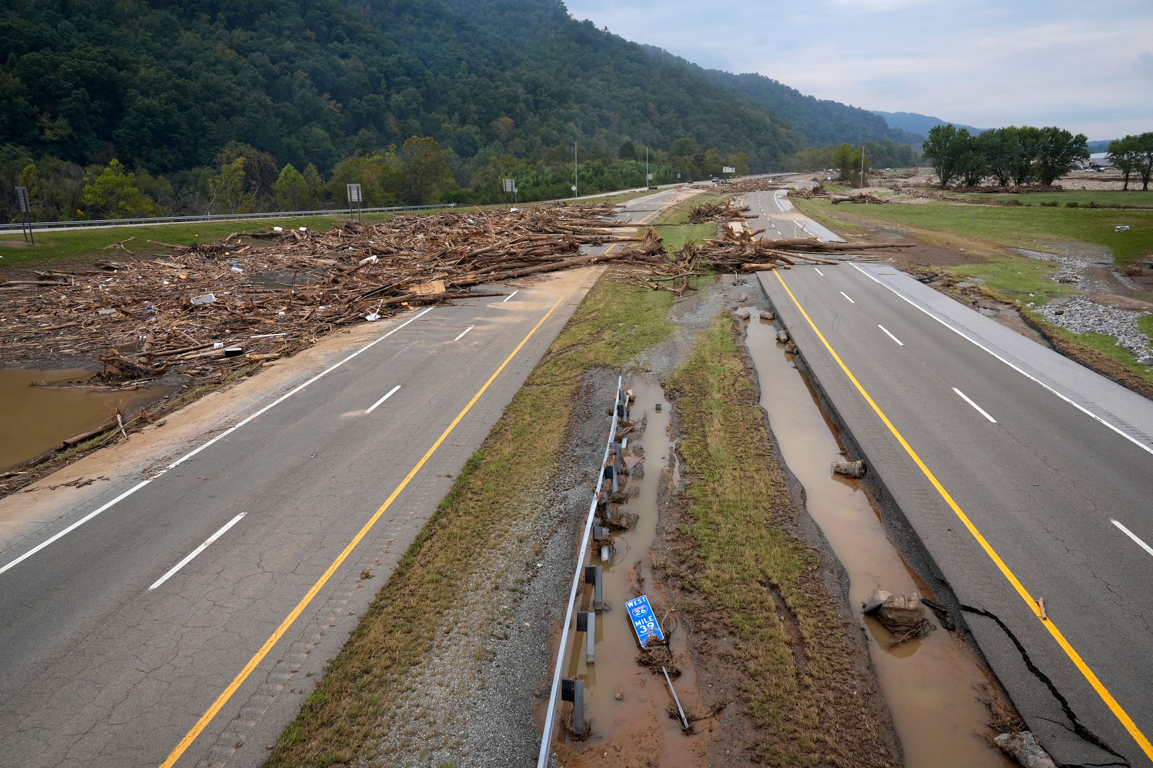 Debris covers the roadway along Interstate 26 in the aftermath of Hurricane Helene, Friday, Oct. 4, 2024, in Erwin, Tenn. (AP Photo/Jeff Roberson)