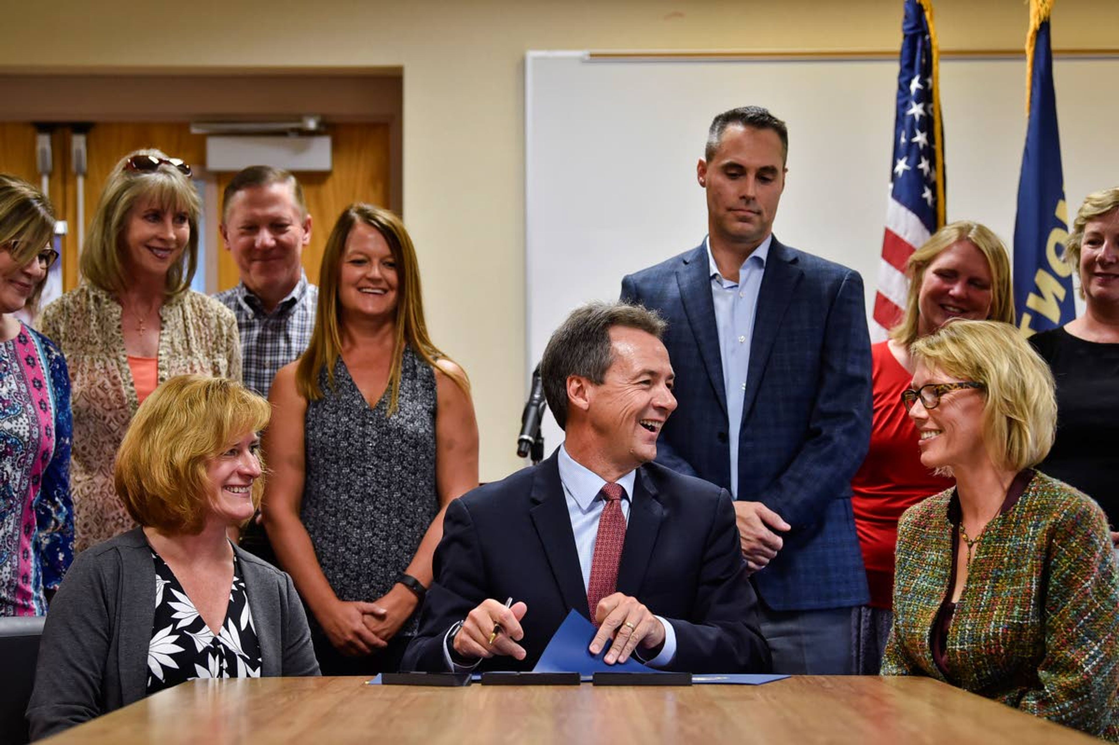 Gov. Steve Bullock, flanked by healthcare industry representatives, signs an executive order establishing Big Sky Care Connect as the state’s designated Health Information Exchange Wednesday at St. Peter’s Health in Helena, Mont.