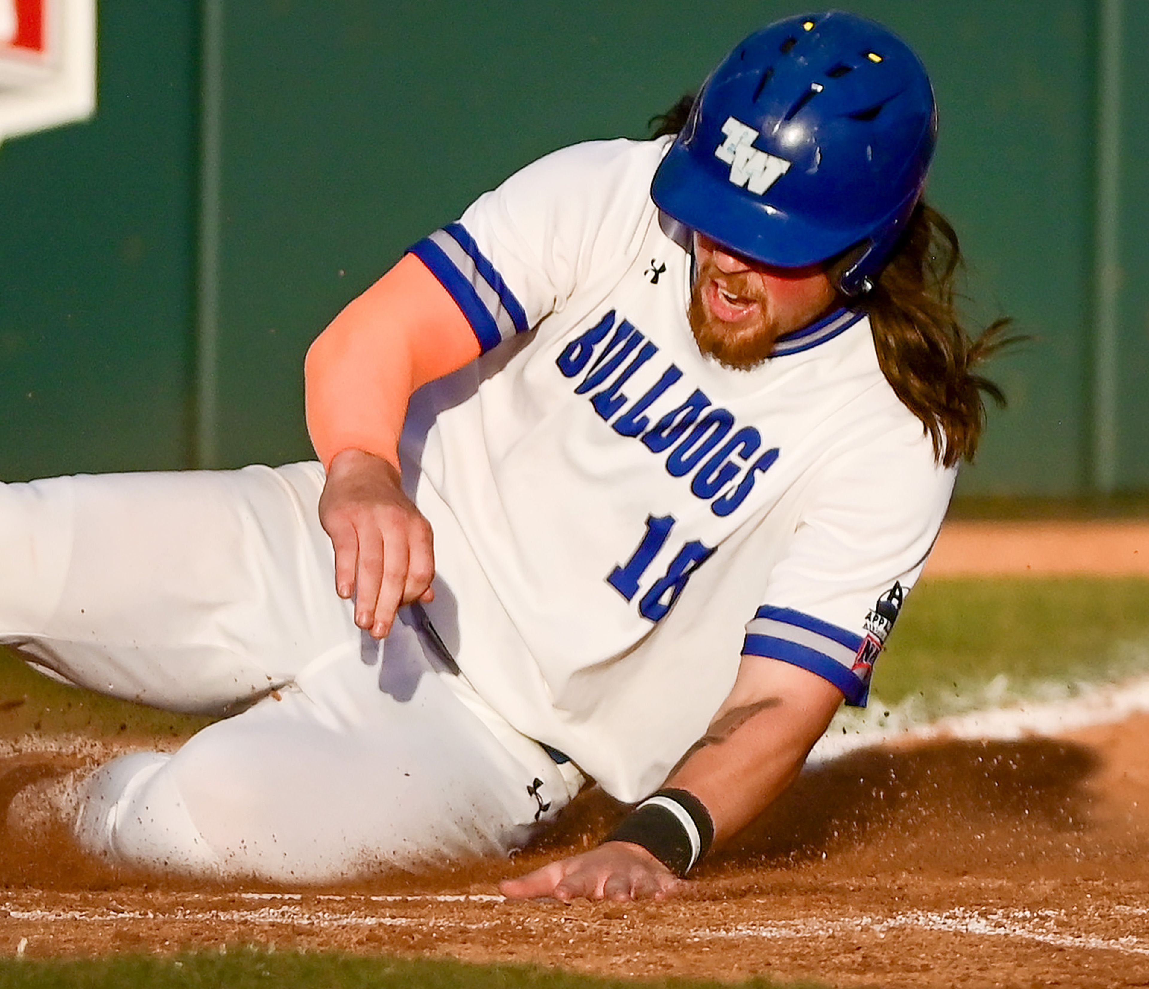 Tennessee Wesleyan’s Evan Magill slides into home plate in Game 18 of the NAIA World Series against Reinhardt at Harris Field in Lewiston on Thursday.