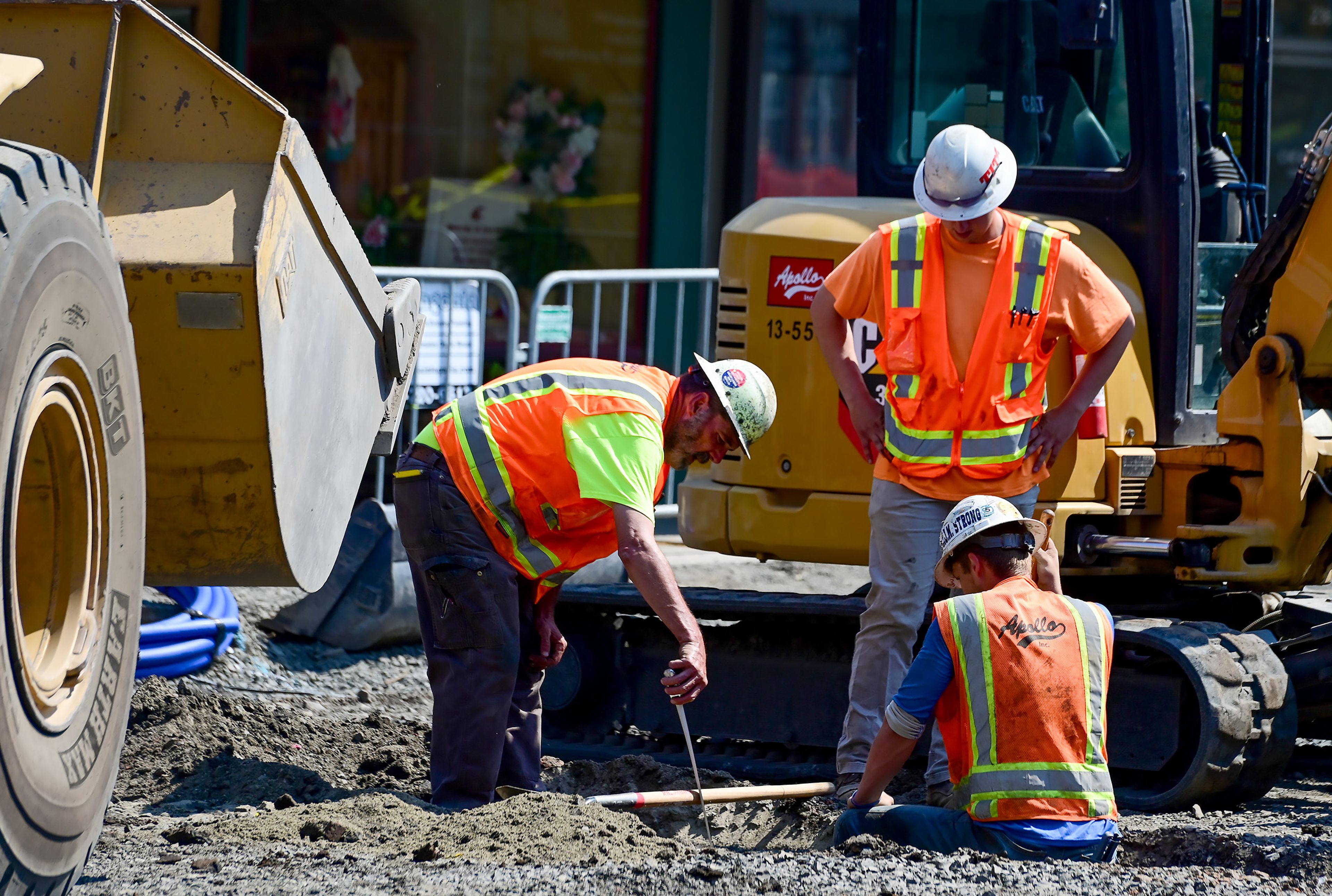 Crew members measure and mark where to dig along Main Street in Pullman on Wednesday as part of the ongoing construction taking place downtown.